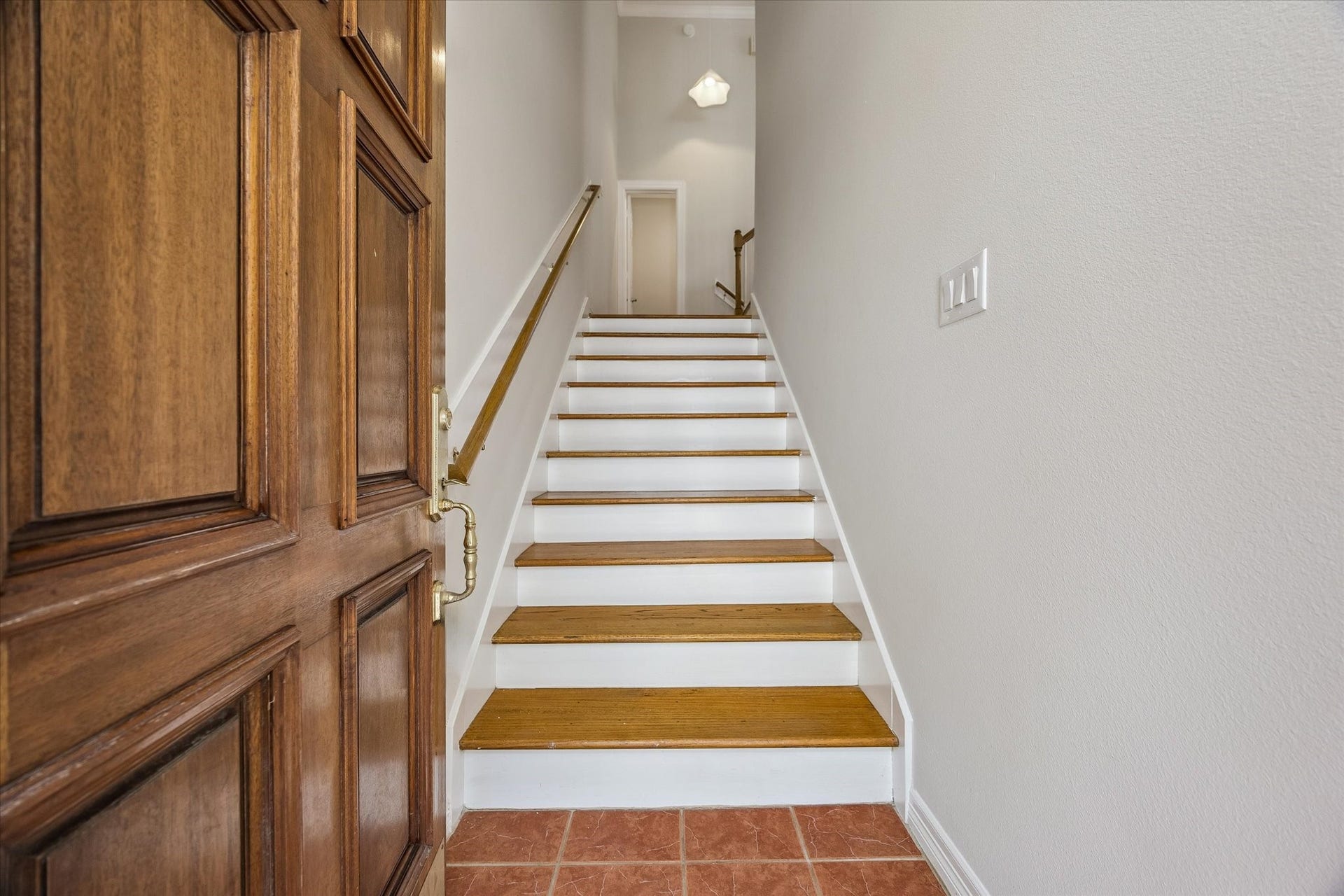 Beyond solid wood door is entry stairwell!