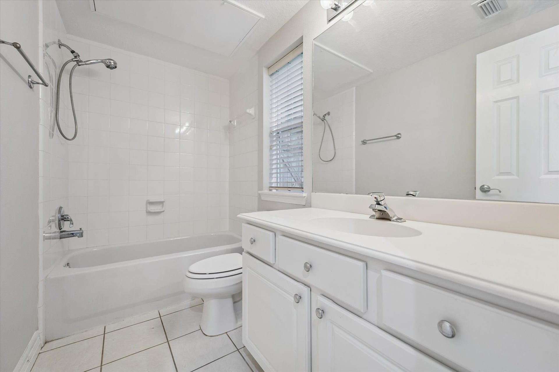 Cute & tidy! Tub and shower combo with even a little window for natural light and fresh air! Good-sized countertop here as well!