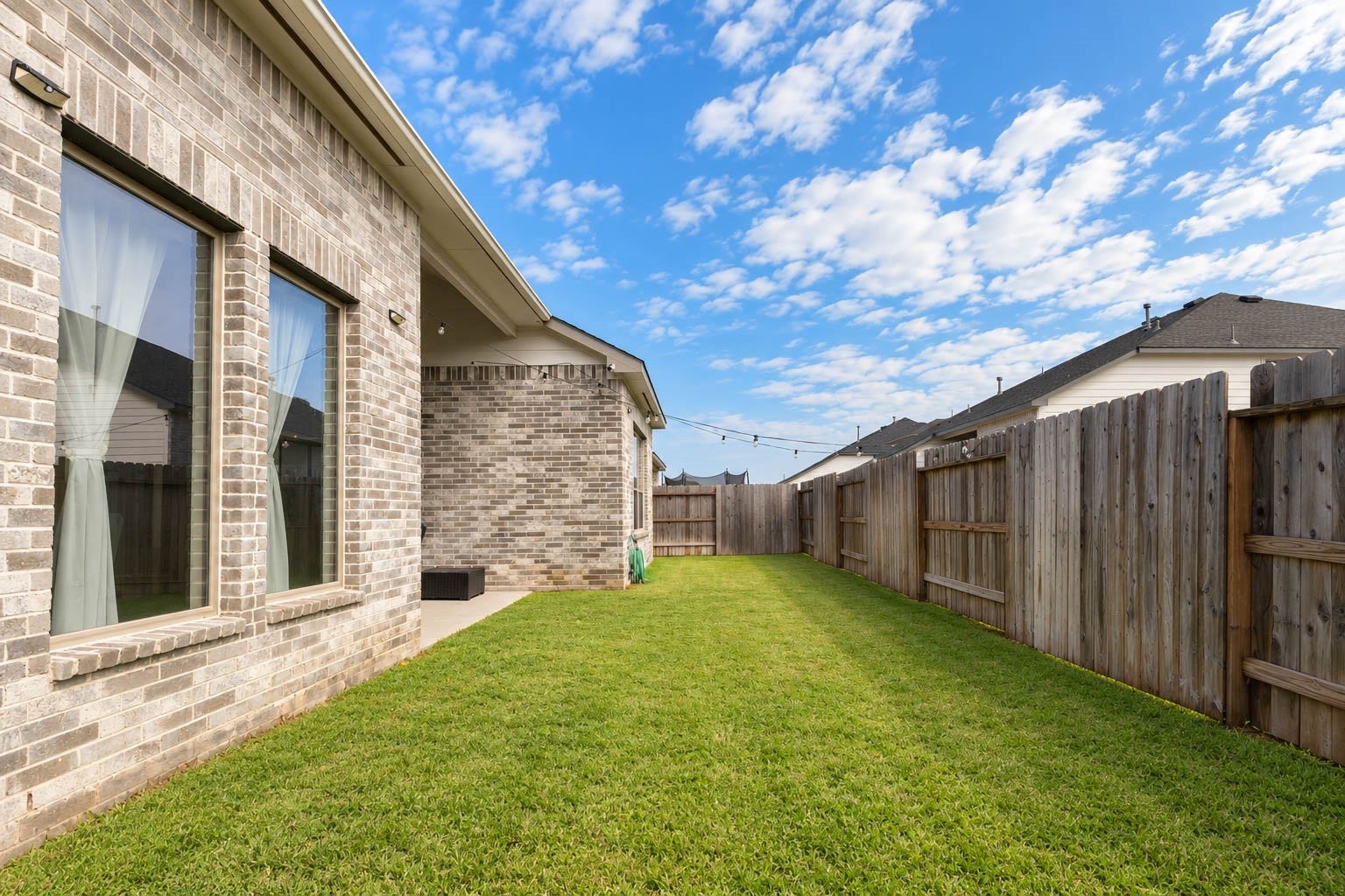 3165 Stingray Cove Drive, Katy, TX 77493 Fully fenced for privacy, the yard offers flexibility for play, pets, gardening, or future outdoor enhancements, while the homes substantial brick exterior adds an attractive backdrop.