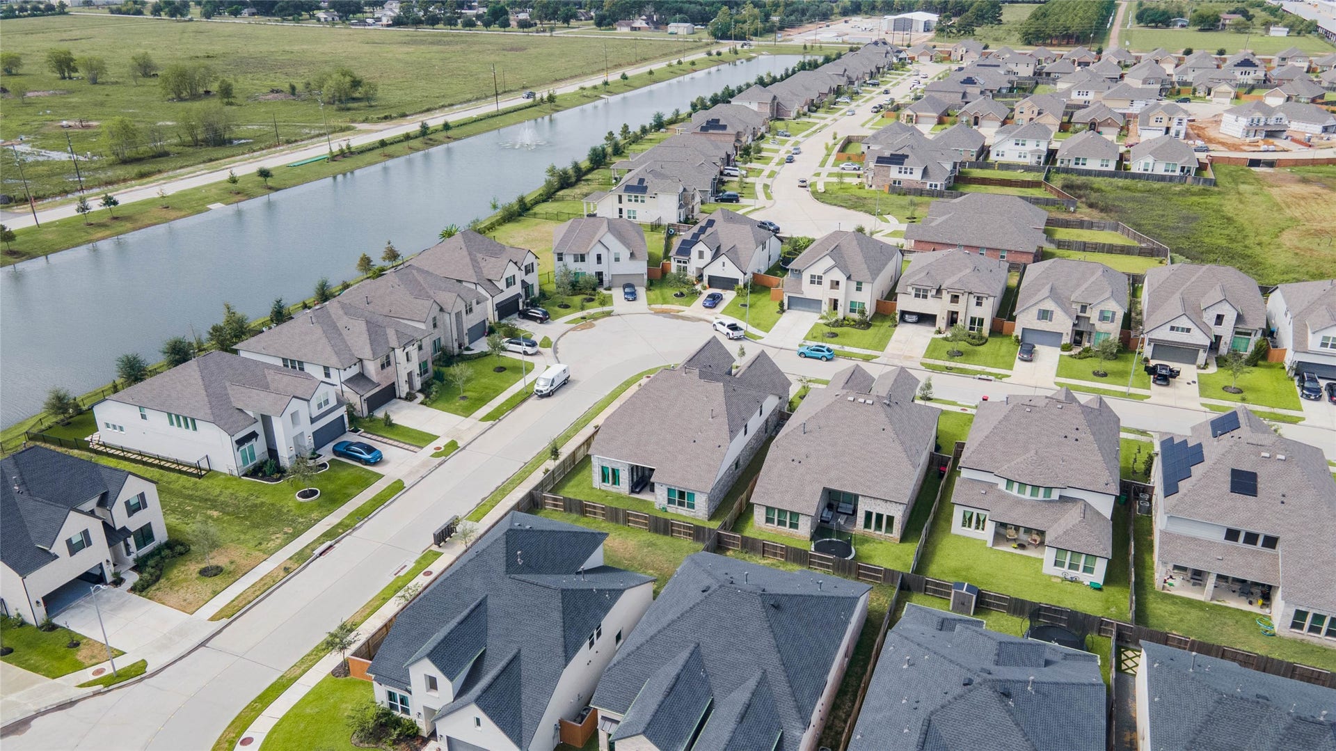 3165 Stingray Cove Drive, Katy, TX 77493 A striking aerial showcases one of Sunterras expansive lakes stretching alongside the neighborhood. Scenic water features are a defining part of the community, complementing its sidewalks, residential streets, and extensive recreational offerings.