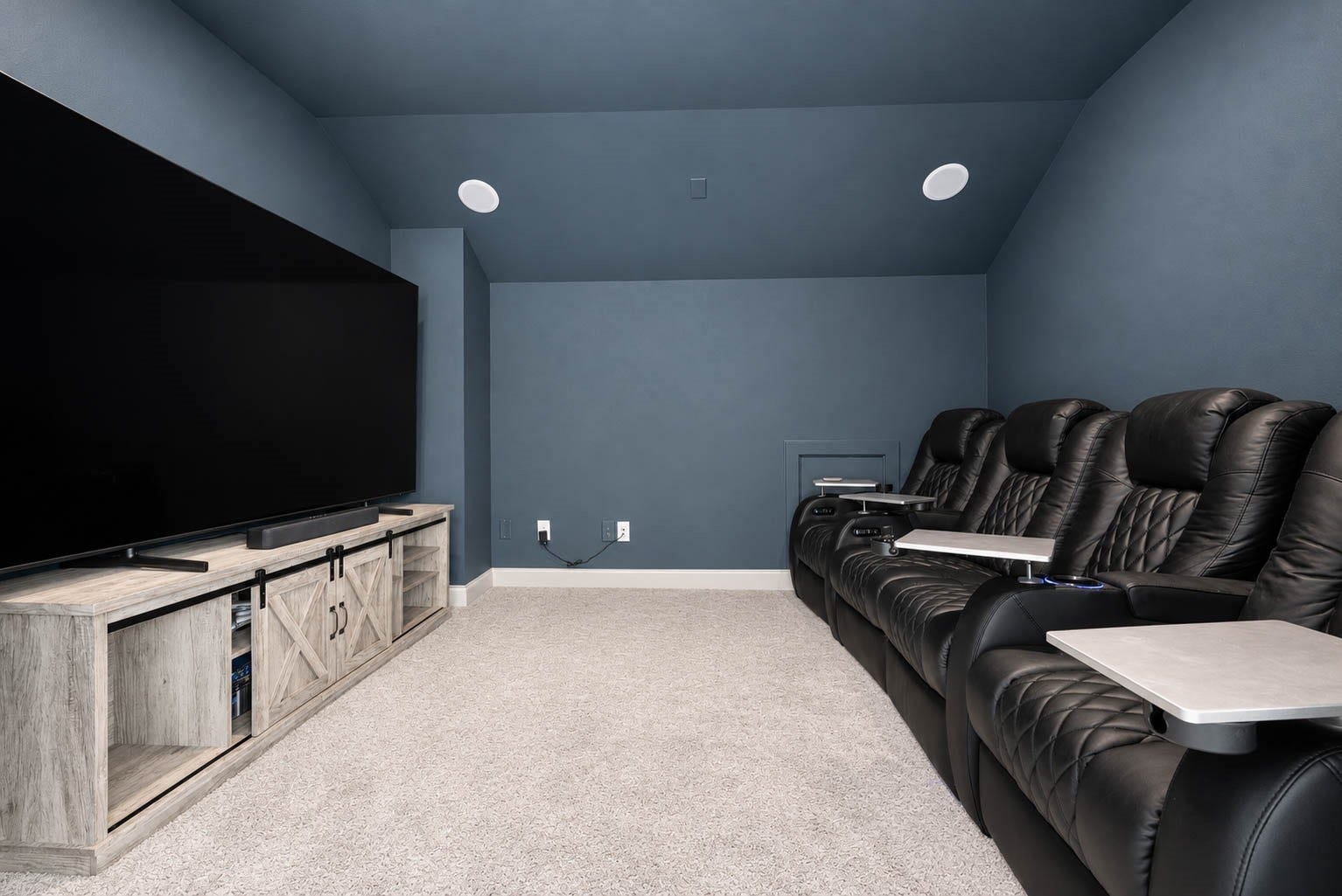 3165 Stingray Cove Drive, Katy, TX 77493 Step inside the dedicated media room, designed for an immersive at-home theater experience. Rich, dramatic walls and ceiling create the perfect cinematic setting, complemented by built-in speakers, plush carpeting, and generous space for seating and a large screen.