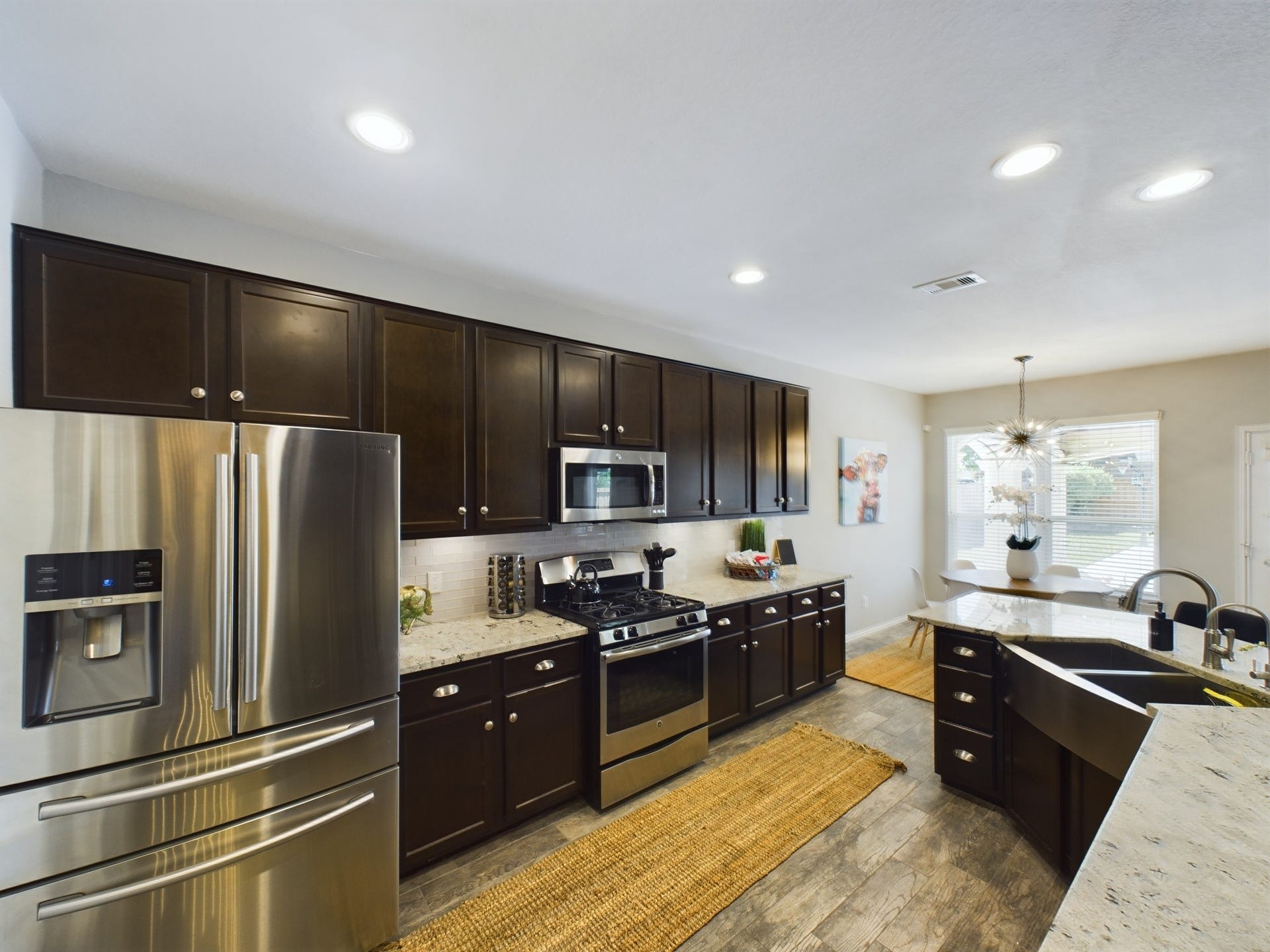 Double Farmhouse Sink, SS Dishwasher, OTR Microwave, French Door Refrigerator and Gas Oven/Range