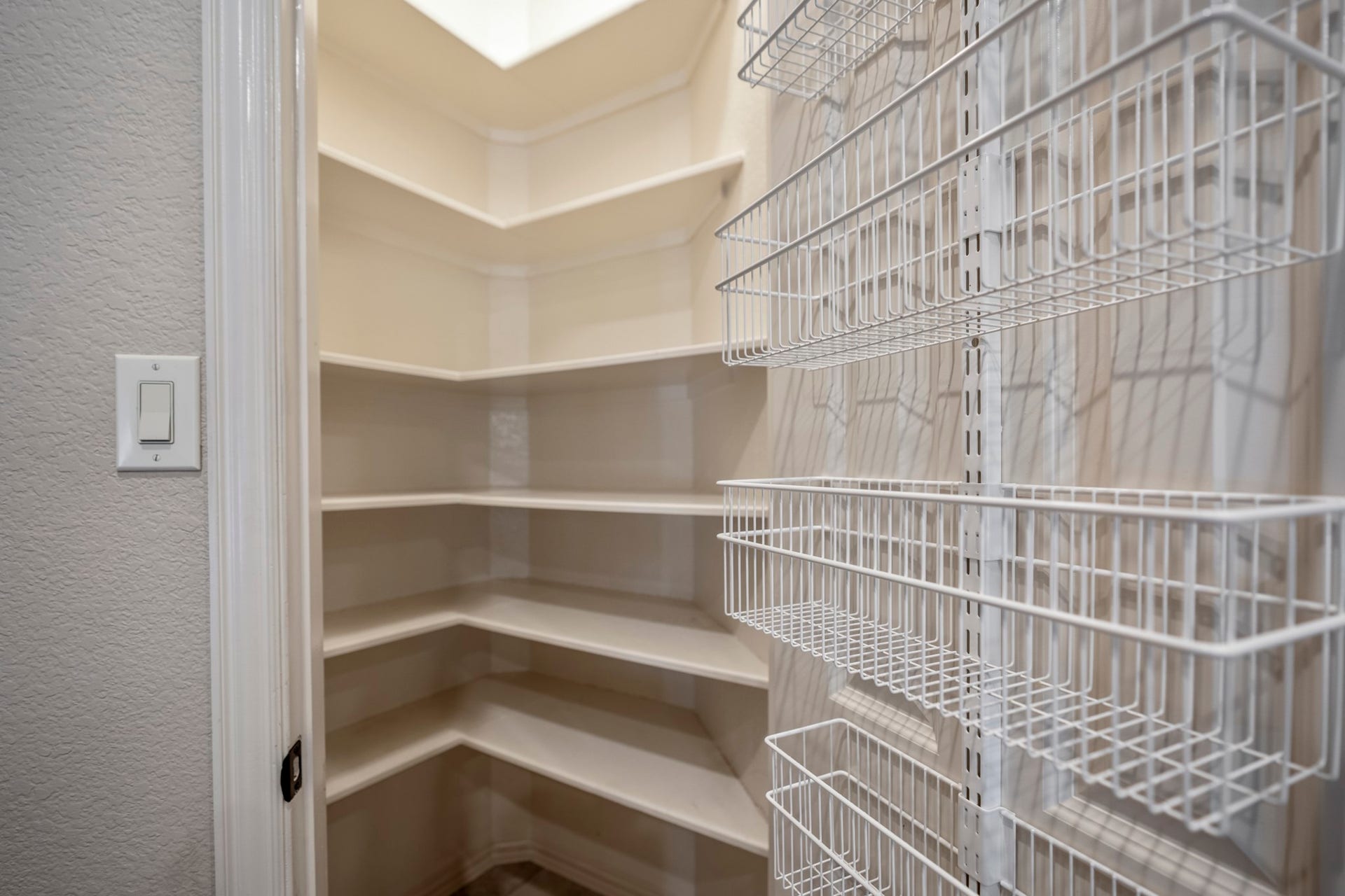 2407 Hendricks Lakes Drive, Spring, TX 77388 The pantry adds easy-to-reach storage with wraparound shelving and door-mounted racks for smaller items. Positioned right beside the working side of the kitchen, it keeps ingredients, serving pieces, and overflow neatly tucked away while staying close to the island, appliances, and main prep areas.