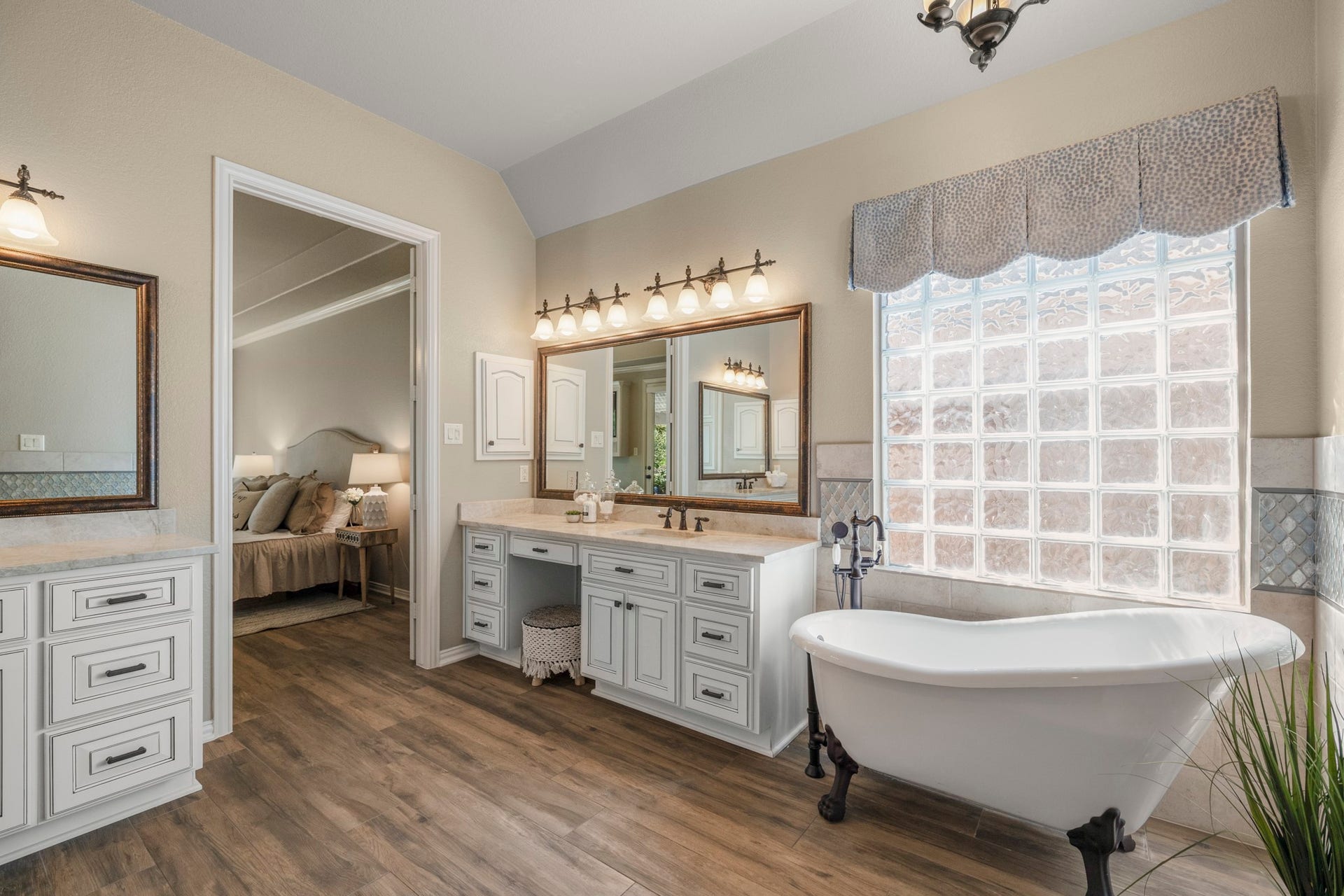 2407 Hendricks Lakes Drive, Spring, TX 77388 Taking one final look at the remodeled primary bath, the custom finishes feel especially polished with Taj Mahal quartzite, framed mirrors, upgraded lighting, and oil-rubbed bronze fixtures carrying across the dual vanities. The freestanding clawfoot tub and glass-enclosed shower complete the retreat-like feel, keeping the primary suite focused on comfort, finish, and a slower start or end to the day.
