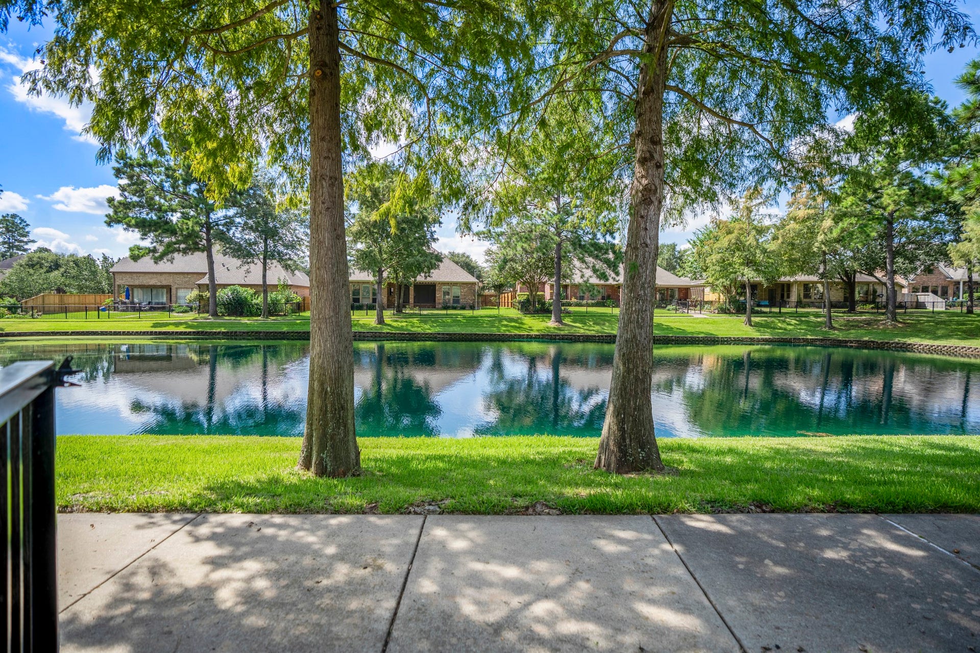 2407 Hendricks Lakes Drive, Spring, TX 77388 From the trail just beyond the backyard, the Lakes of Cypress Forest setting feels peaceful and scenic, with water views, mature trees, and green space stretching along the path. This is the lifestyle piece buyers can feel outside the fence line morning walks, shaded views, and a water-front backdrop that extends the backyard experience into the neighborhood.