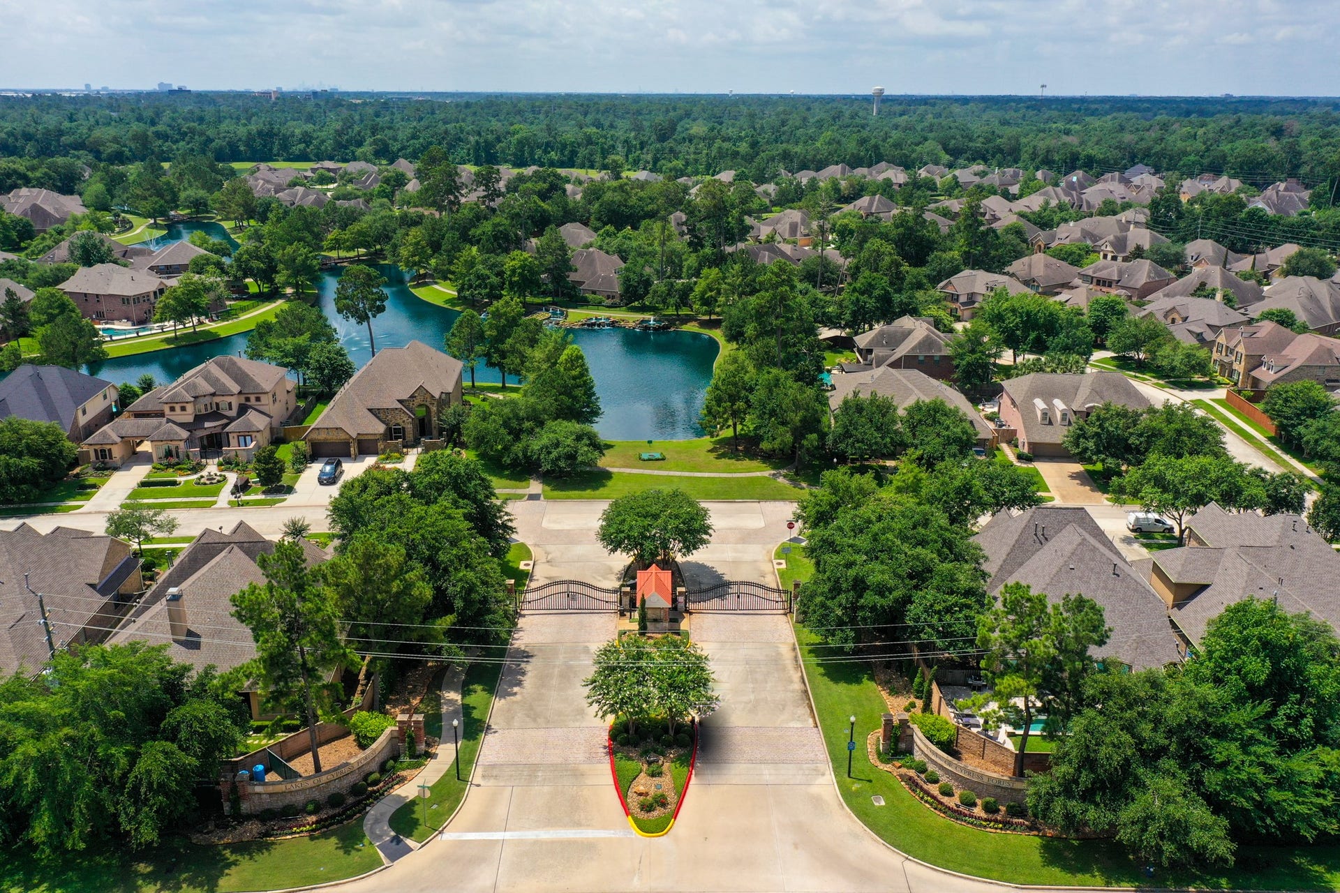 2407 Hendricks Lakes Drive, Spring, TX 77388 From above, Lakes of Cypress Forest shows off its gated entrance, lake-centered layout, and wooded surroundings, giving buyers a better feel for the setting before they ever reach the home. Winding streets, fountains, walking paths, and green space all reinforce the neighborhoods scenic, connected lifestyle just minutes from Spring conveniences.
