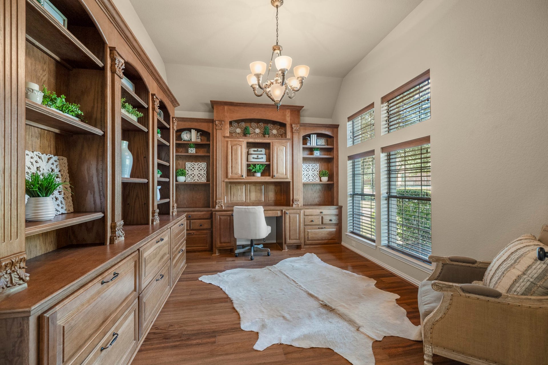 2407 Hendricks Lakes Drive, Spring, TX 77388 Working from home feels a little more inspired in this front study, where French doors, tall windows, and two walls of custom built-ins create a polished space just off the foyer. Rich wood cabinetry, detailed trim, file storage, display shelving, and lower cabinets give the room a library-like feel while keeping it practical for work, reading, or planning the day.