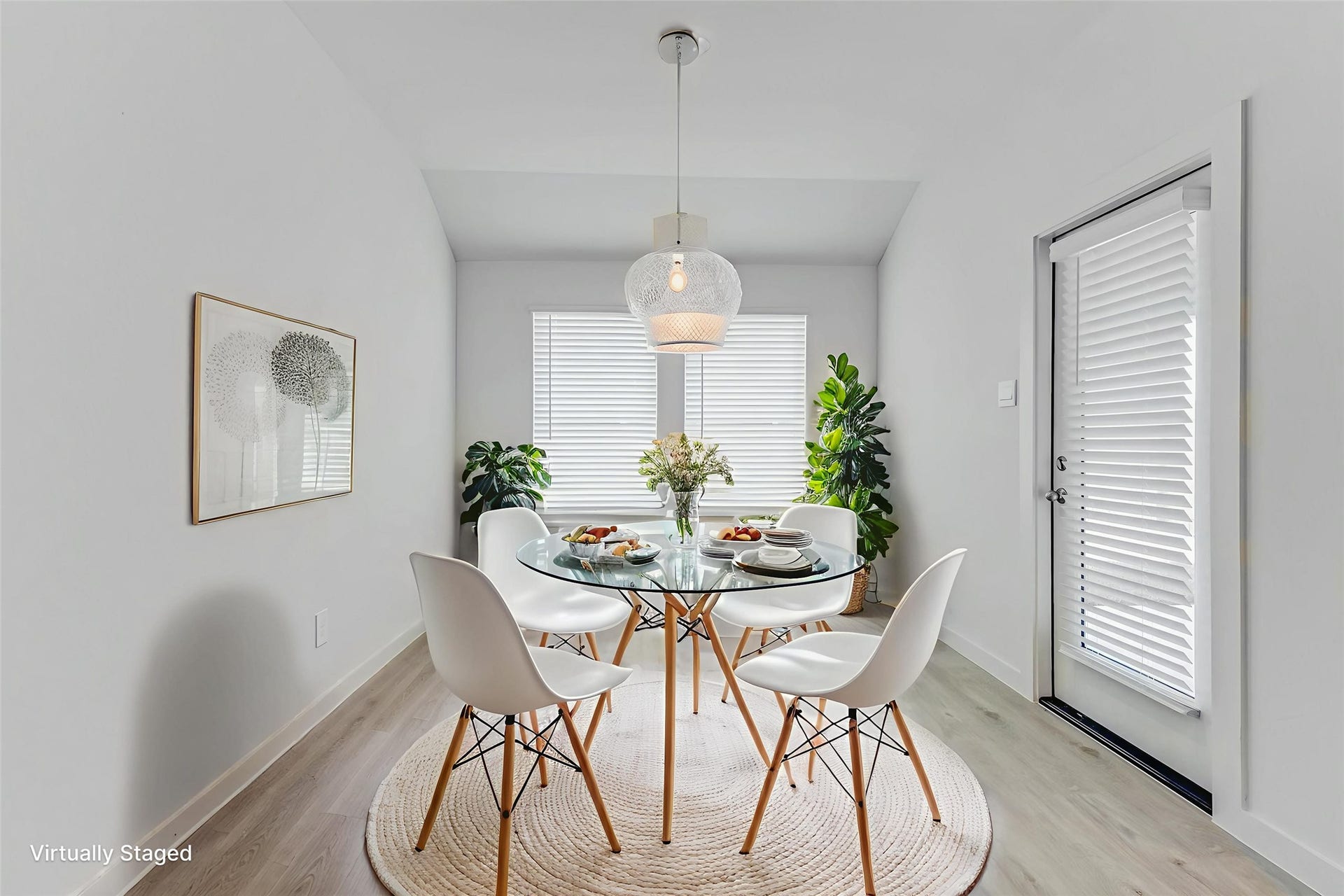 30307 Lighthouse Bluff Lane, Fulshear, TX 77441 Bright, modern dining area. Large windows with blinds and a door let in natural light.