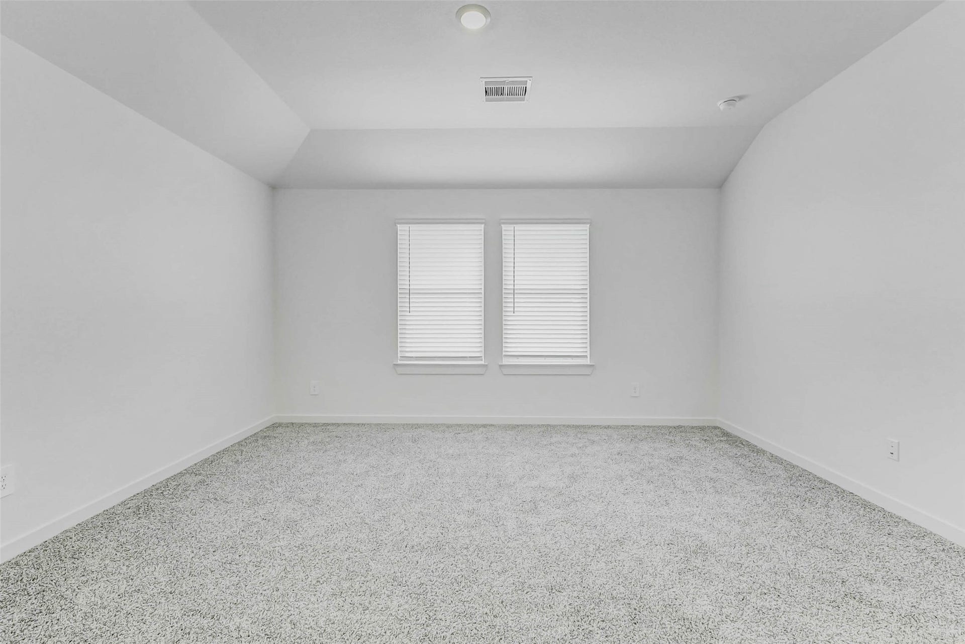 30307 Lighthouse Bluff Lane, Fulshear, TX 77441 Bright, spacious room with neutral walls and carpet, featuring two large windows for natural light.