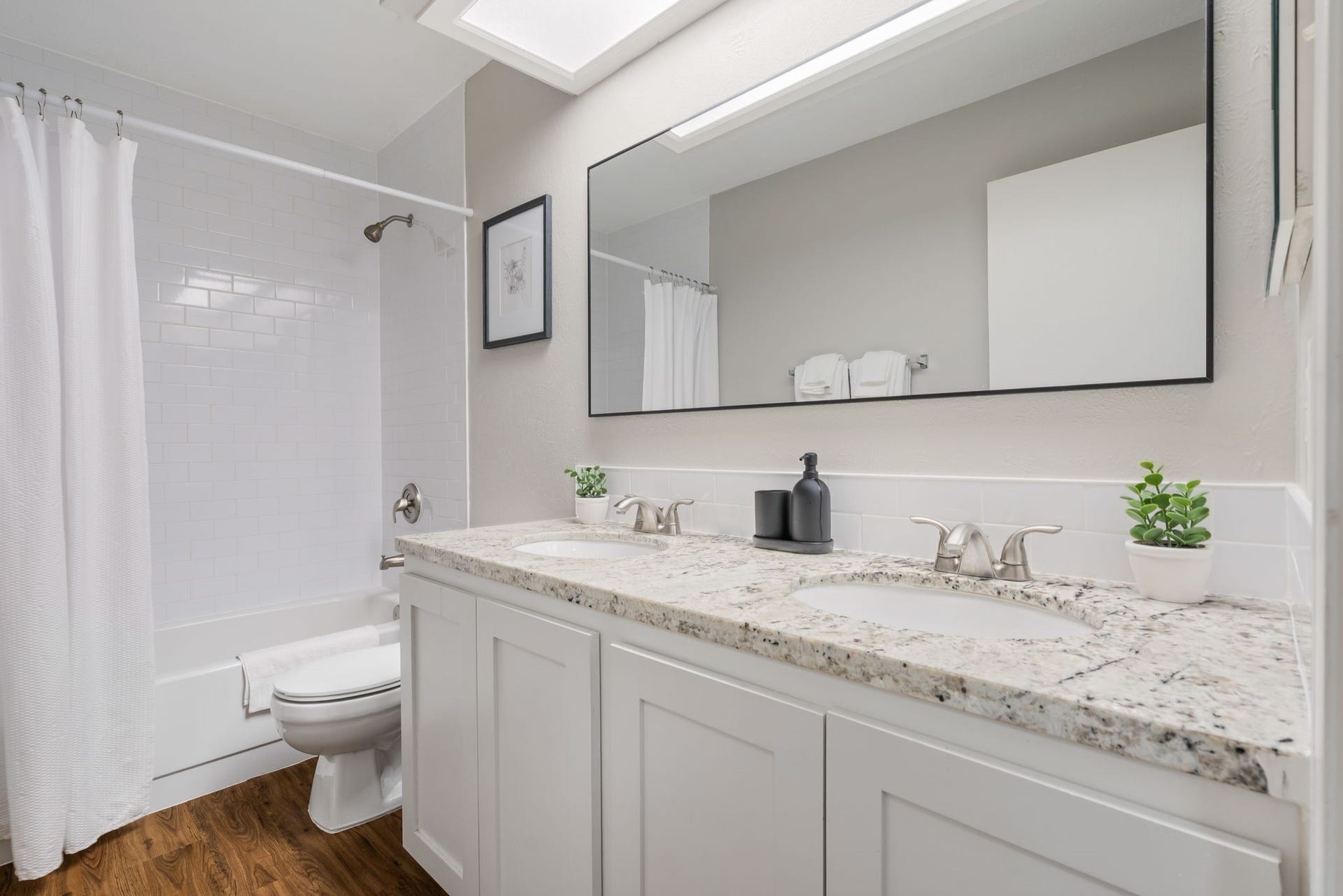 4 Basal Briar Court, The Woodlands, TX 77381 Secondary bathroom with two sinks.