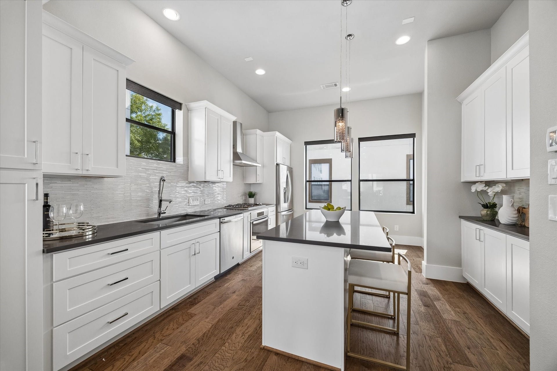 5707 Larkin Street, #B, Houston, TX 77007 The kitchen has excellent cabinet storage on either side, an island with overhang for bar stools, gas cooking, and stainless appliances throughout.