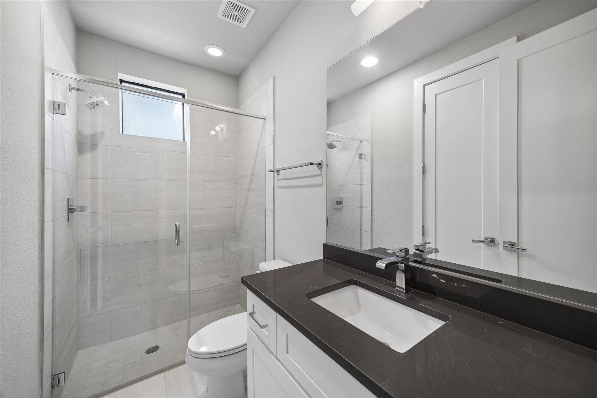 5707 Larkin Street, #B, Houston, TX 77007 First floor en suite bathroom has a frameless standing shower.
