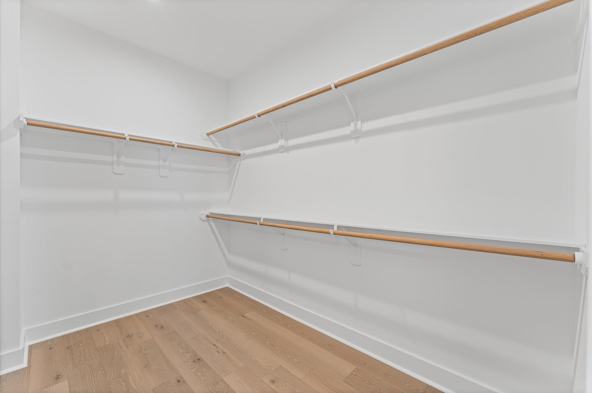 412 Neyland Street, #G, Houston, TX 77022 This well-proportioned primary closet offers a practical blend of space and organization, ideal for everyday use. With ample room for hanging garments and shelving for folded items or accessories, it balances functionality with comfort.