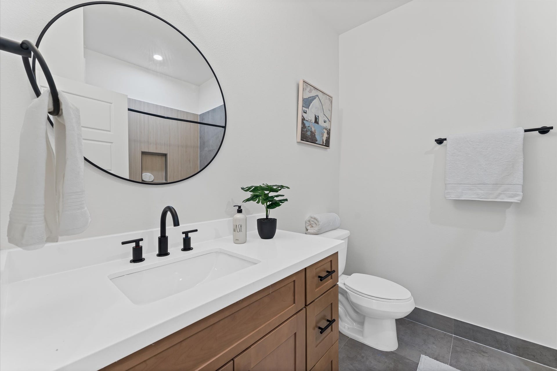 412 Neyland Street, #G, Houston, TX 77022 This secondary bathroom on the second floor is designed to serve two adjacent bedrooms with both style and functionality. It offers ample space for shared use, while the tub-shower combo provides versatility for quick rinses or relaxing soaks. The space is elevated by contemporary finishes and sleek tilework, creating a clean, modern aesthetic that feels both fresh and refined.