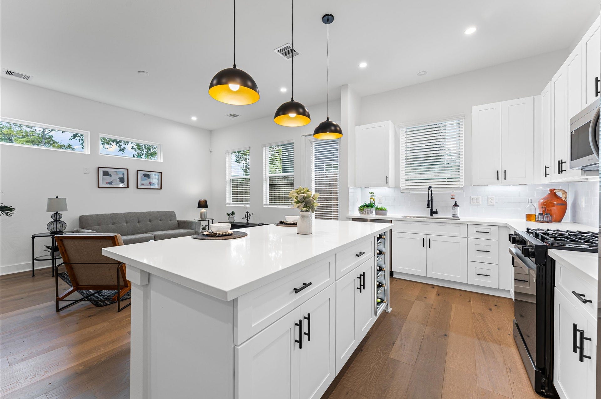 412 Neyland Street, #G, Houston, TX 77022 This centrally positioned kitchen island serves as a stylish anchor within the open-concept layout, offering clear sightlines to the dining area, living space, and the backyard beyond. Its placement encourages seamless interaction, whether prepping meals or entertaining guests, while natural light pours in through the nearby windows. The islands sleek design and functional surface make it a hub of activity, framed by elegant finishes tying together comfort and sophistication.