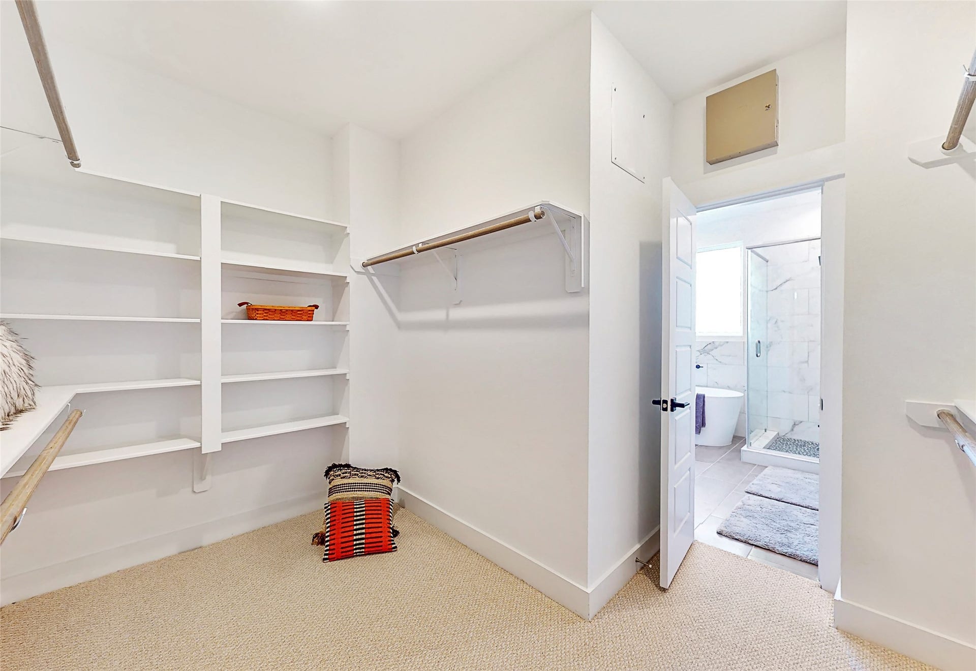 412 Neyland Street, #G, Houston, TX 77022 This well-proportioned primary closet offers a practical blend of space and organization, ideal for everyday use. With ample room for hanging garments and shelving for folded items or accessories, it balances functionality with comfort.
