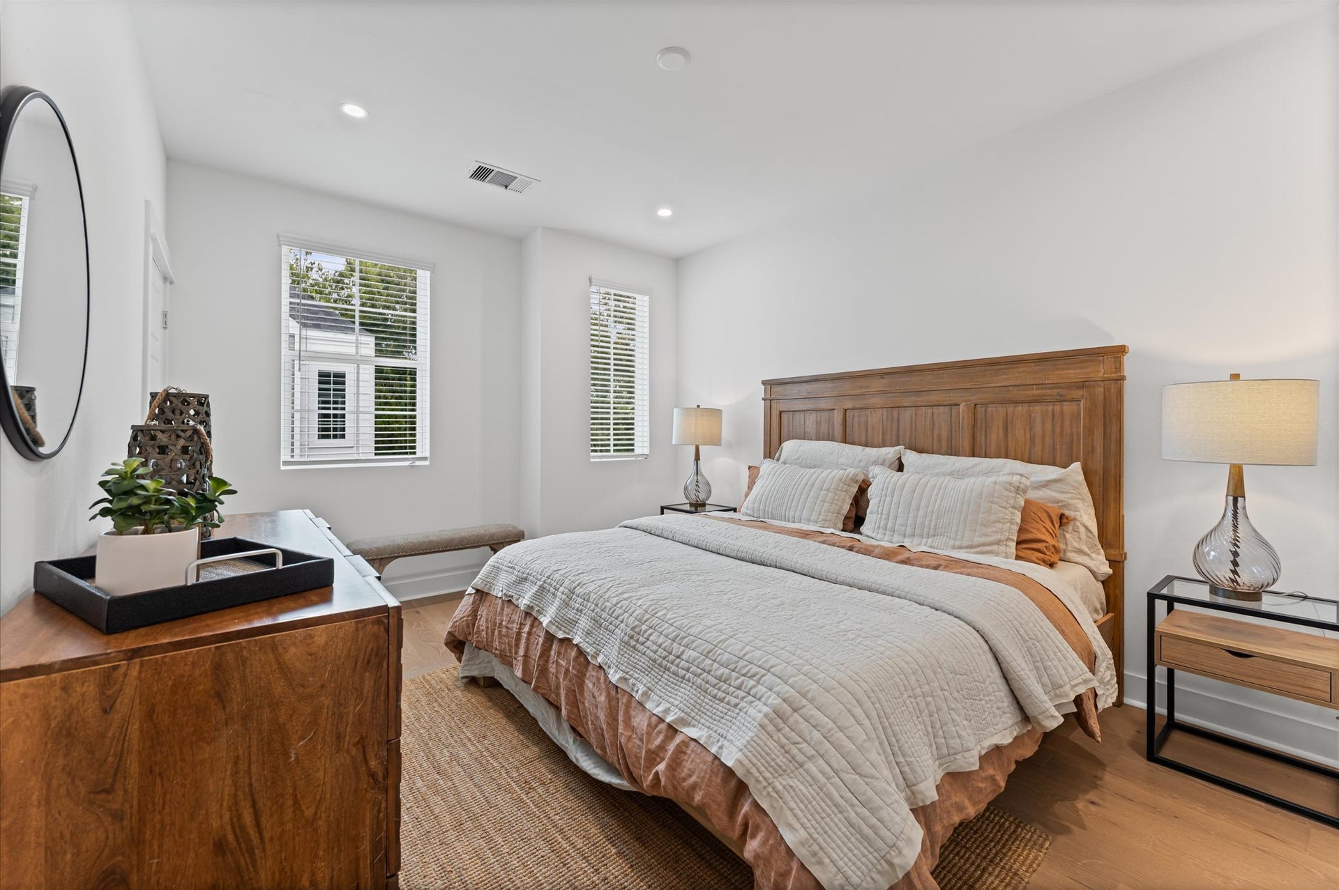 412 Neyland Street, #G, Houston, TX 77022 This spacious second-floor primary bedroom exudes modern elegance with its sleek engineered wood flooring that adds warmth and texture underfoot. Soaring high ceilings amplify the sense of openness, allowing natural light to cascade in and highlight the rooms architectural charm. Whether styled with minimalist furnishings or layered with cozy accents, the space offers a serene retreat elevated by its refined finishes and elevated vantage point.