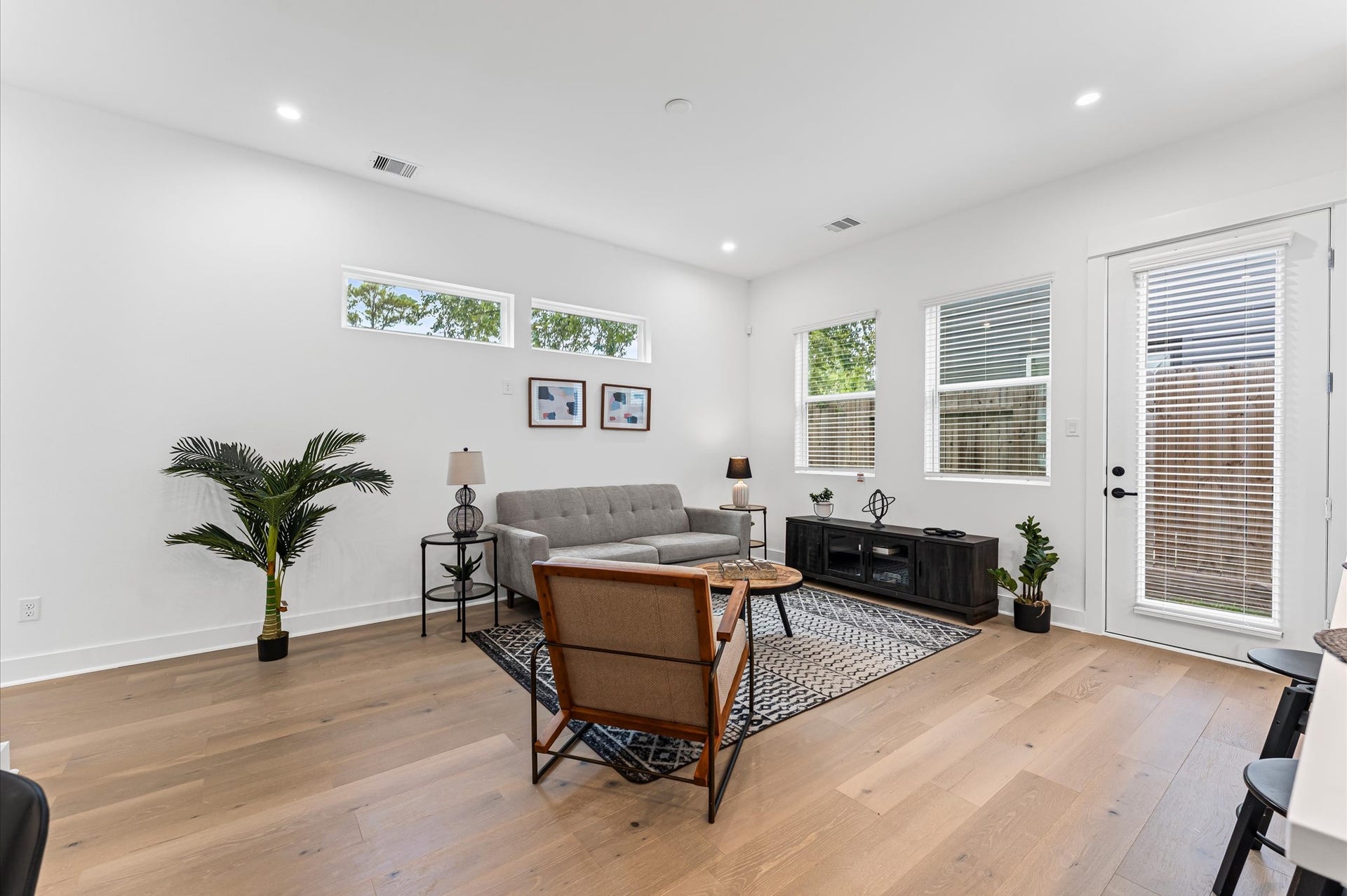 412 Neyland Street, #G, Houston, TX 77022 This inviting home features a spacious open-concept layout on the first floor, seamlessly connecting the living, dining, and kitchen areas to create a warm and functional gathering space. Large windows and glass door direct access to the backyard flooding the interior with natural light and extending the living space outdoors, perfect for entertaining or relaxing in the fresh air. The thoughtful design balances comfort and flow, making everyday living feel effortlessly connected to nature.