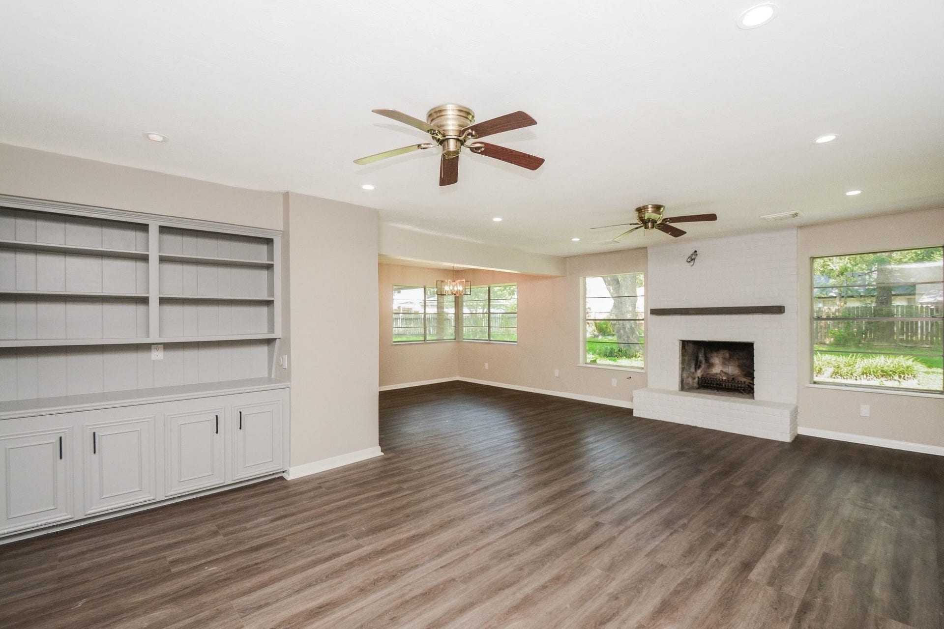 3018 Apple Valley Lane, Missouri City, TX 77459 This sleek view of open living space is accented by the focal built in fireplace. and set-in cupboard storage, left. Imagine this space at holiday time! Huge picture windows bring the lush green outdoors, inside!