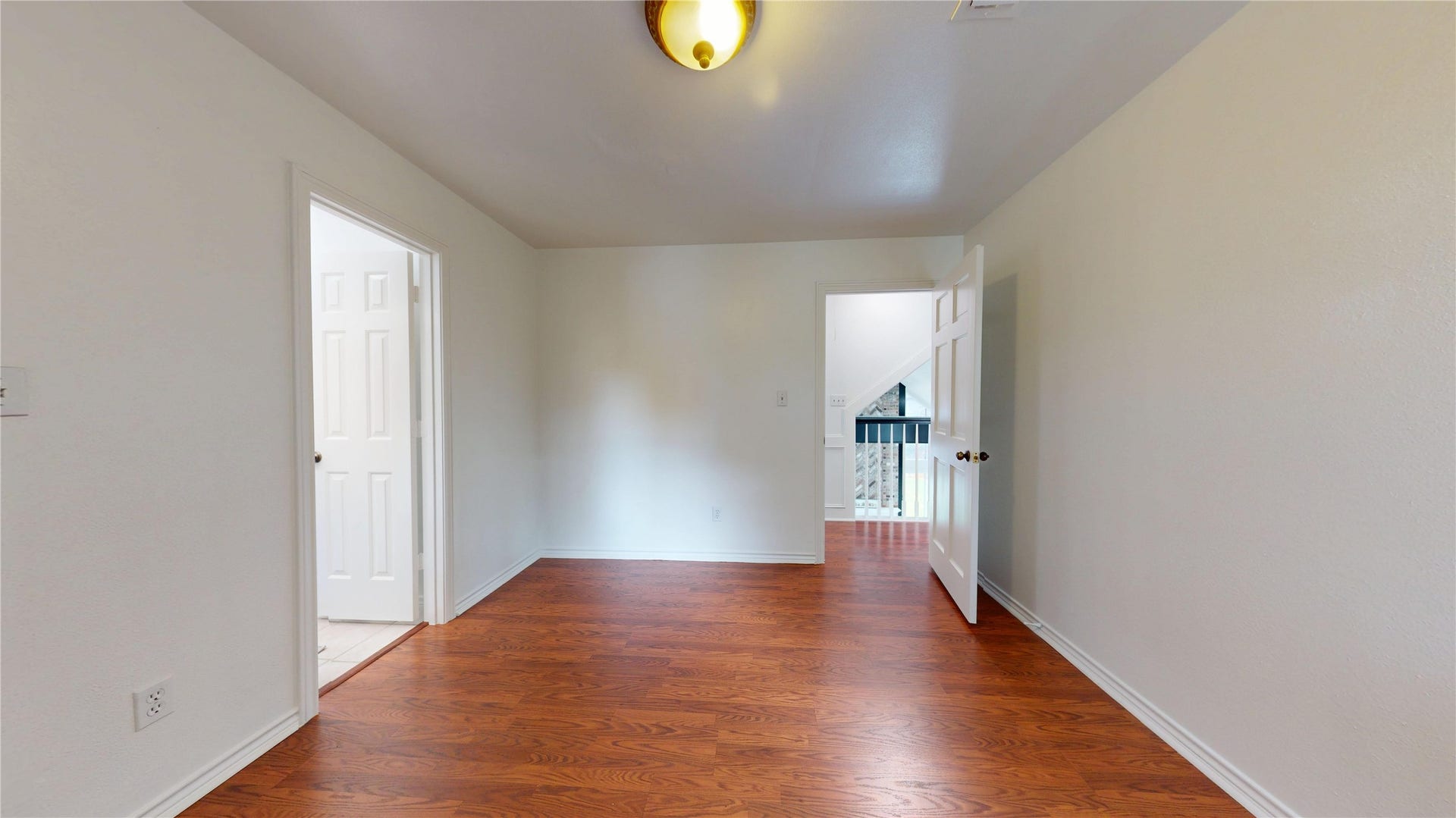 1407 Sherfield Ridge Drive, Katy, TX 77450 1407 Sherfield Ridge Dr, Bedroom #3 on the 2nd floor with wooden laminate flooring, walk-in closet and entry to jack-and-jill bathroom.