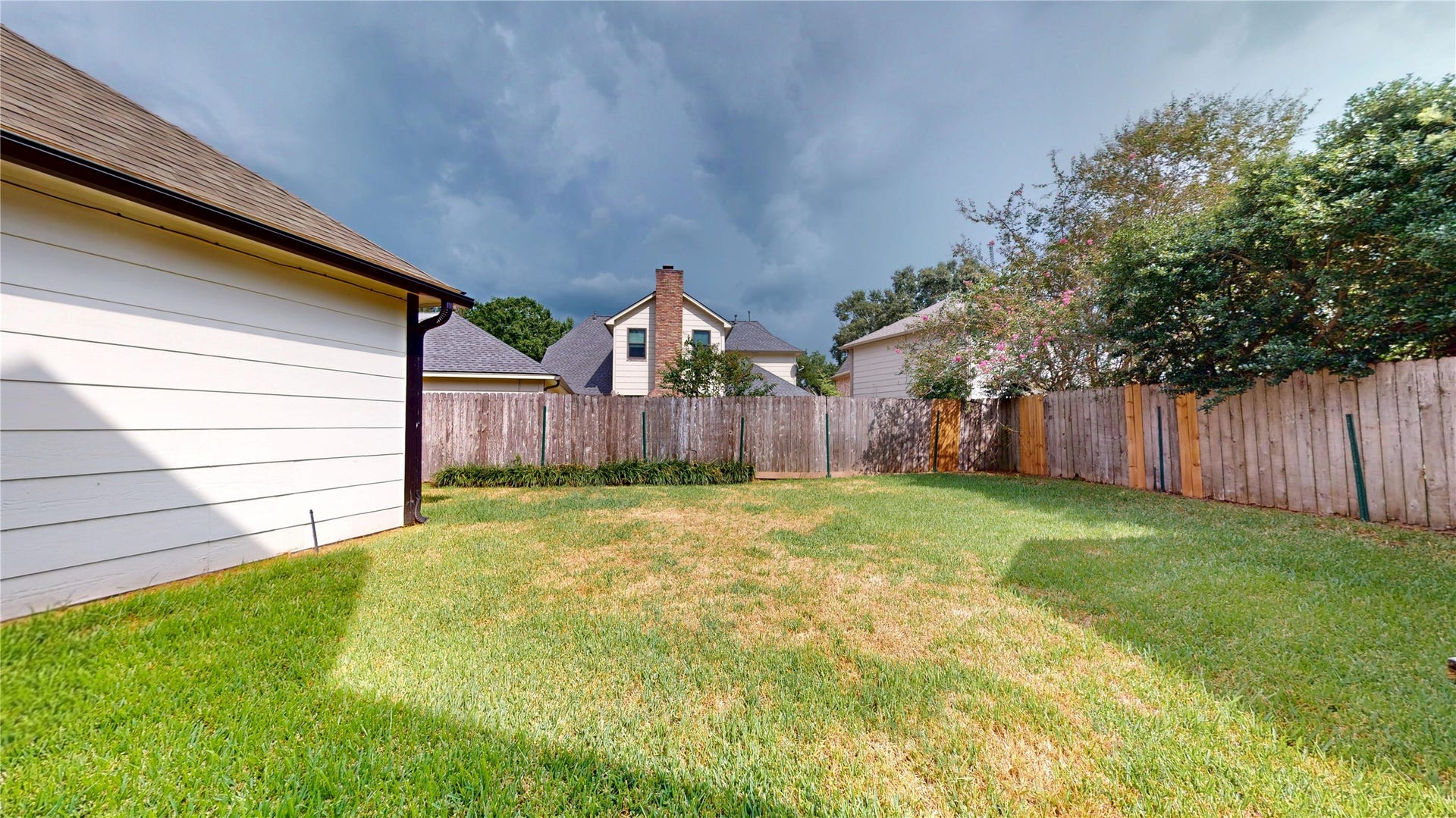 1407 Sherfield Ridge Drive, Katy, TX 77450 1407 Sherfield Ridge Dr, Other side of the backyard, fully fenced with plenty of green lawn space perfect for BBQ gatherings.