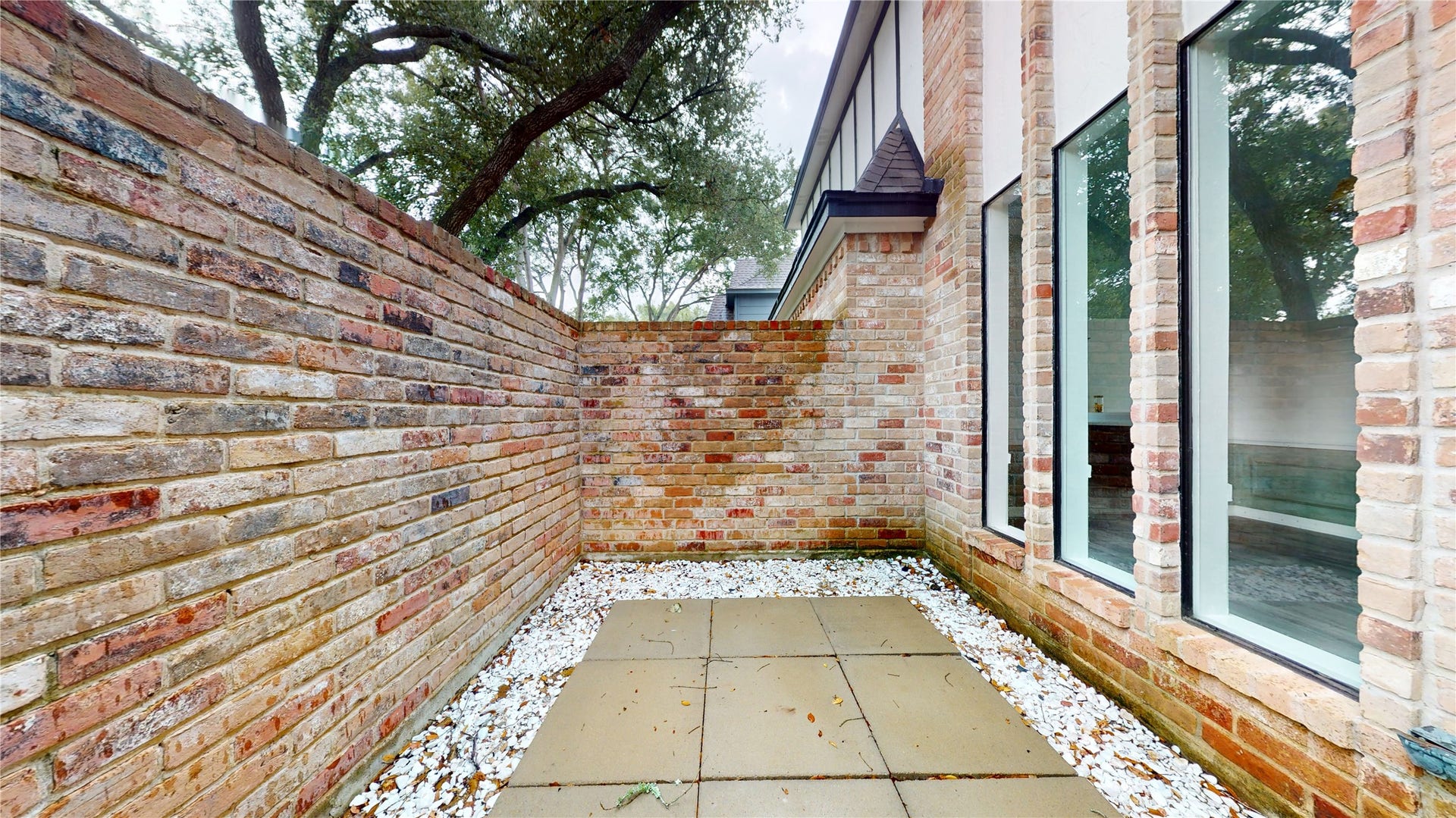 1407 Sherfield Ridge Drive, Katy, TX 77450 1407 Sherfield Ridge Dr, Outdoor space on left side of door entrance, with brick wall for privacy.