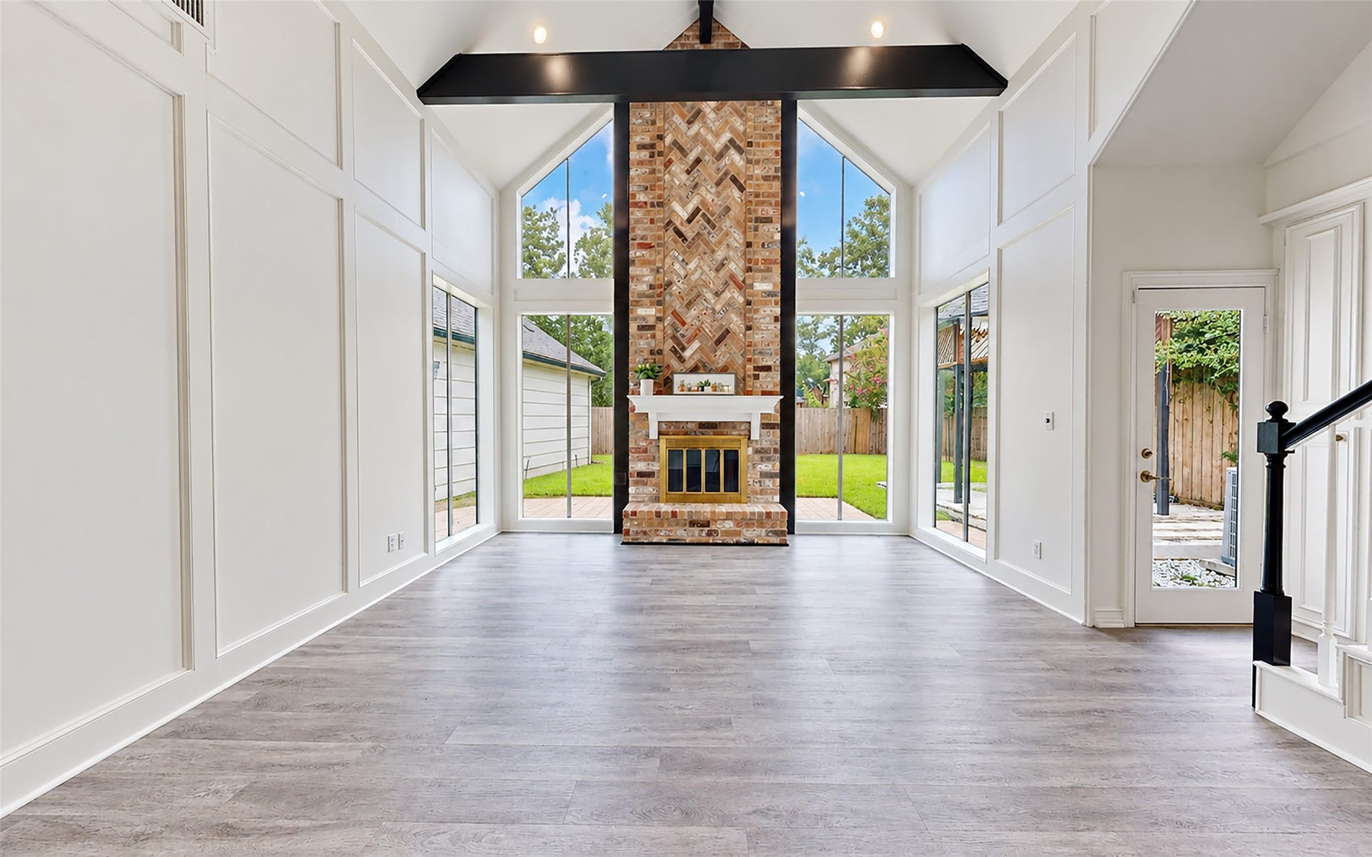 1407 Sherfield Ridge Drive, Katy, TX 77450 1407 Sherfield Ridge Dr, Stunning open-concept living area! Soaring vaulted ceilings, decorative wall mokding and abundant natural light from dramatic floor-to-ceiling windows and a striking floor-to-ceiling brick fireplace with a unique herringbone pattern accent. it has mondern wooden laminate flooring and direct access to the backyard/patio area.