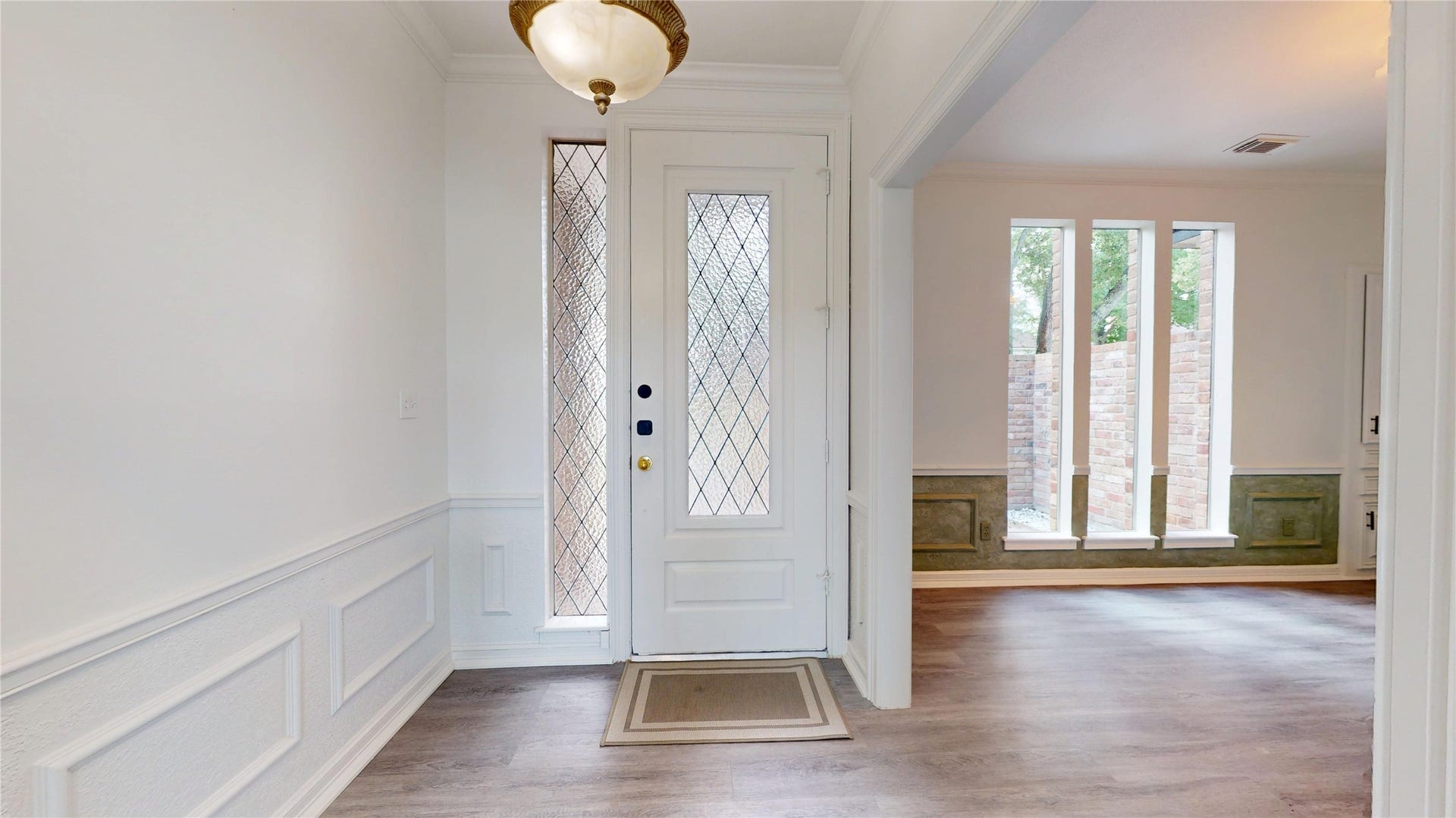 1407 Sherfield Ridge Drive, Katy, TX 77450 1407 Sherfield Ridge Dr, Welcoming entryway accented with elegat picture-frame wainscoting and a front door with elegant diamond patterned glass. Open layout with formal dining room entrance and long windows facing the covered front patio.