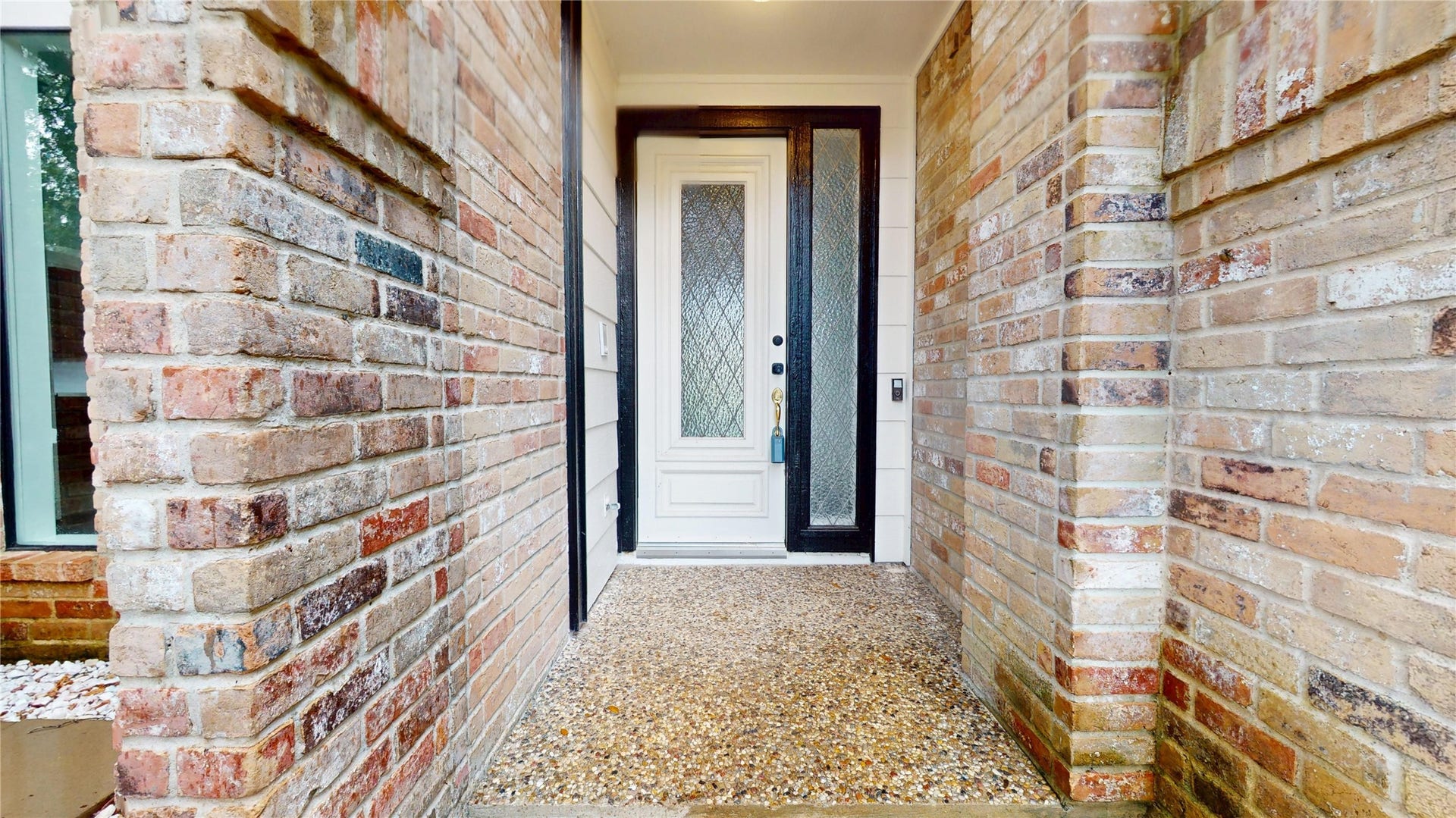 1407 Sherfield Ridge Drive, Katy, TX 77450 1407 Sherfield Ridge Dr, Welcoming covered front entry framed by brickwork, with charming front white door with decorative glass. Entrance to a patio on left side for outdoor living space.