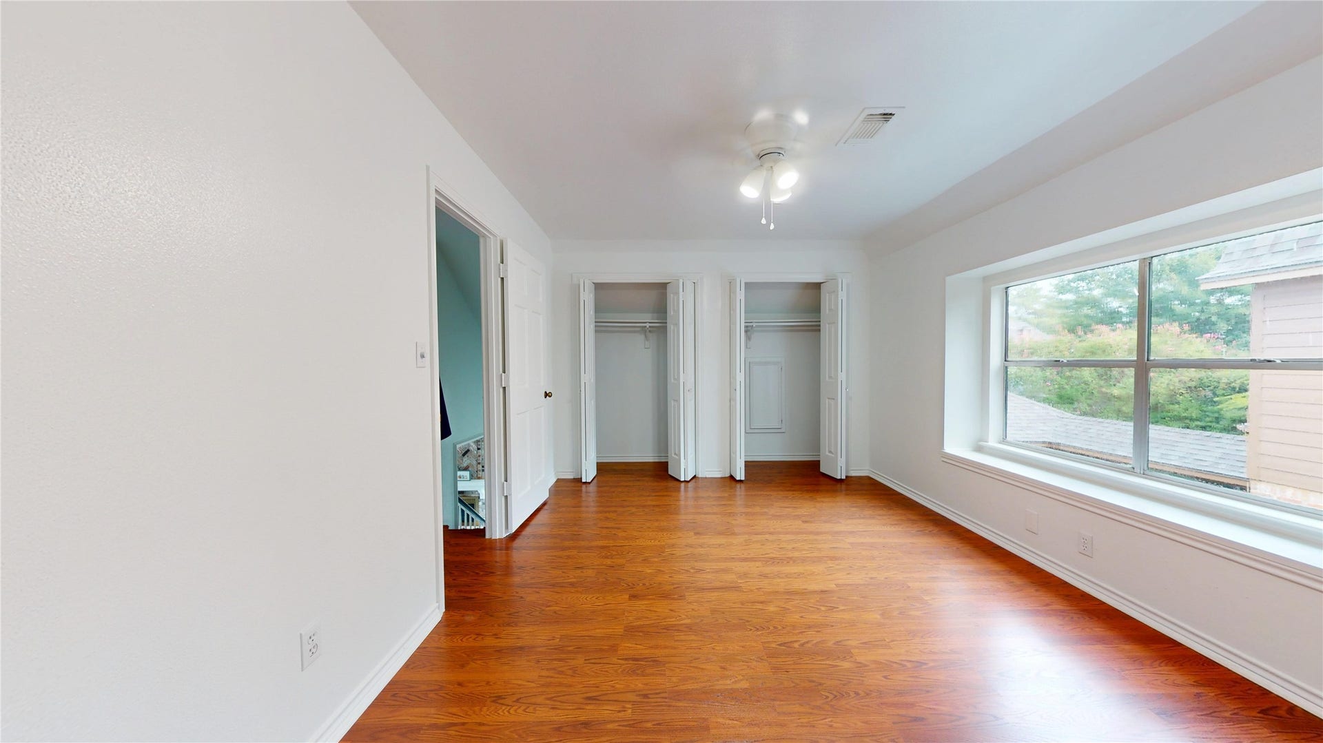 1407 Sherfield Ridge Drive, Katy, TX 77450 1407 Sherfield Ridge Dr, Bedroom #2 located on 2nd floor with double door closet and bay large window for natural lighting. Warm wooden flooring throughout the 2nd floor.