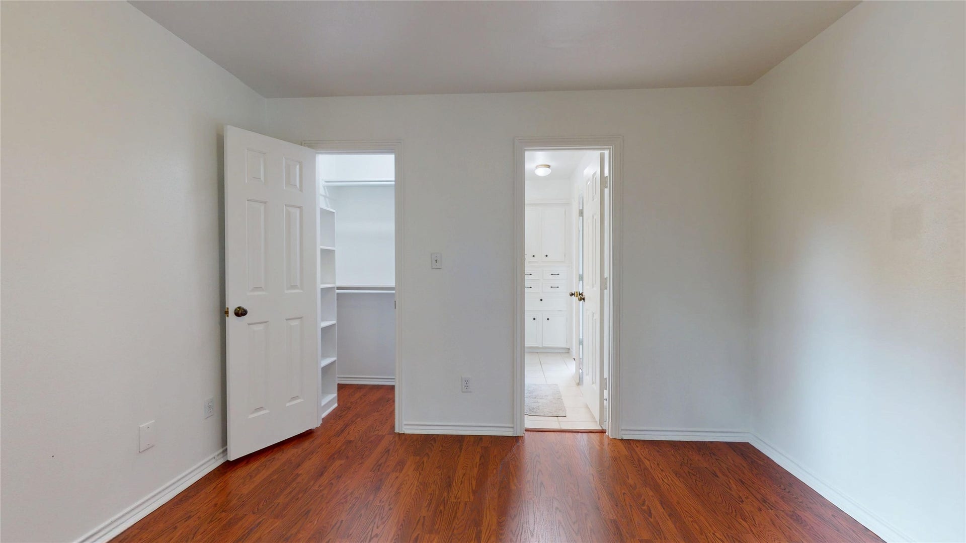 1407 Sherfield Ridge Drive, Katy, TX 77450 1407 Sherfield Ridge Dr, Bedroom #3 on the 2nd floor with wooden laminate flooring, walk-in closet and entry to full bathroom.