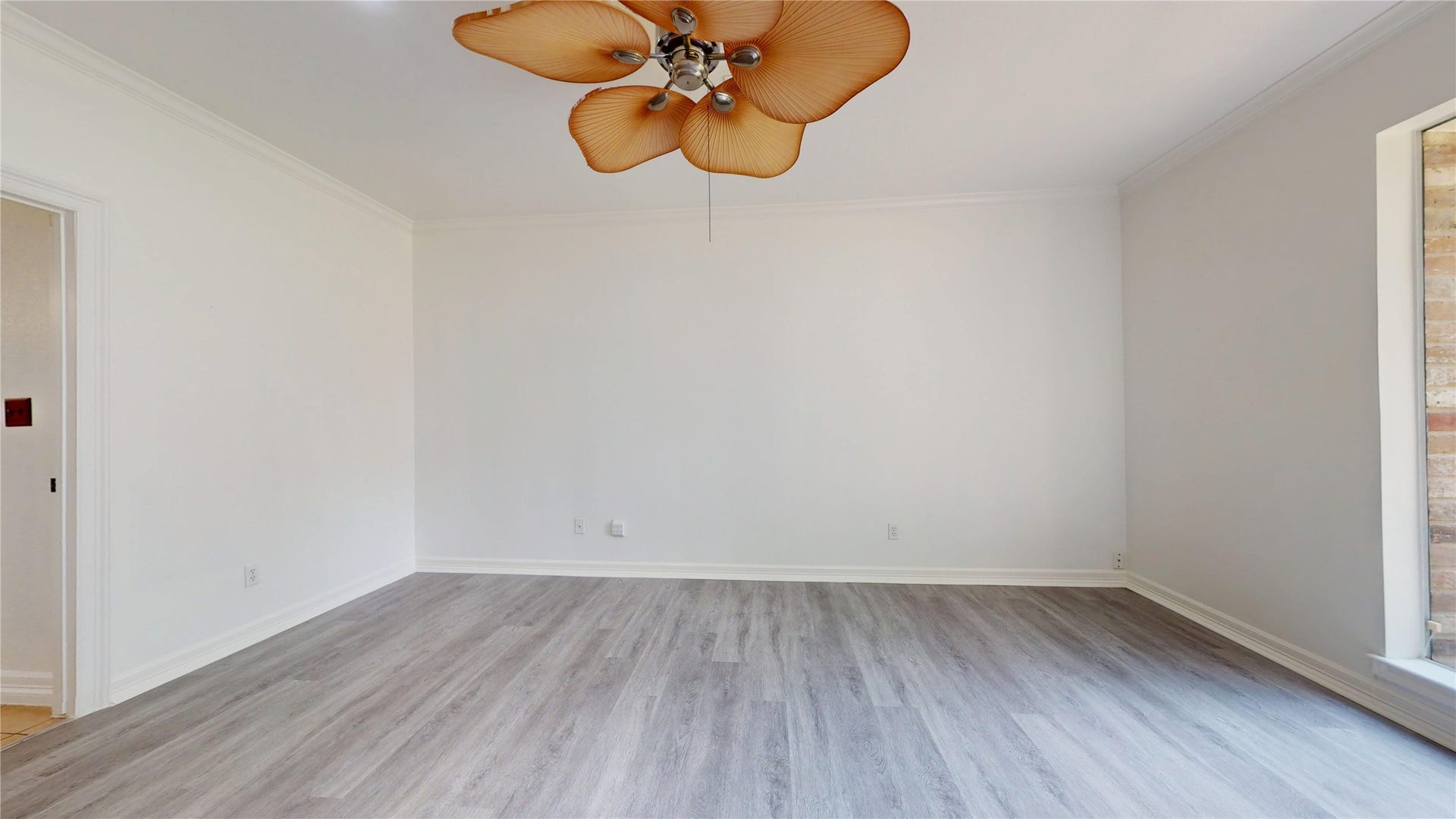 1407 Sherfield Ridge Drive, Katy, TX 77450 1407 Sherfield Ridge Dr, Large primary Bedroom with fresh white walls, wooden laminate and unique tropical inspired ceiling fan. The open layout provides plenty of room for multiple furniture arrangements, while the large window brings in nauural light and offers a beautiful front of the house and neighborhood view.