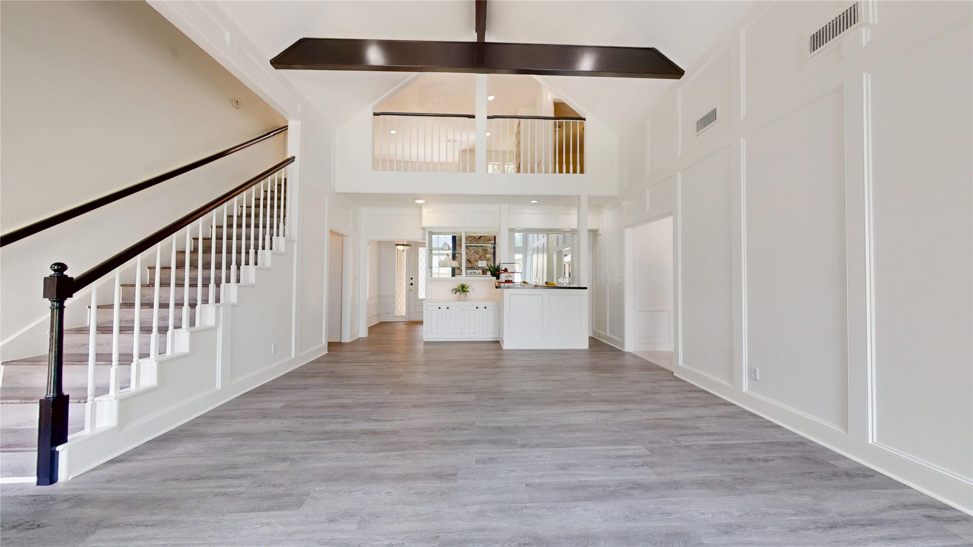 1407 Sherfield Ridge Drive, Katy, TX 77450 1407 Sherfield Ridge Dr, Stunning open-concept living area! Soaring vaulted ceilings, decorative wall molding and modern wooden laminate flooring. Open staircase with contrasting dark handrail complements the architectural details, and the second-floor overlook enhances the open space.