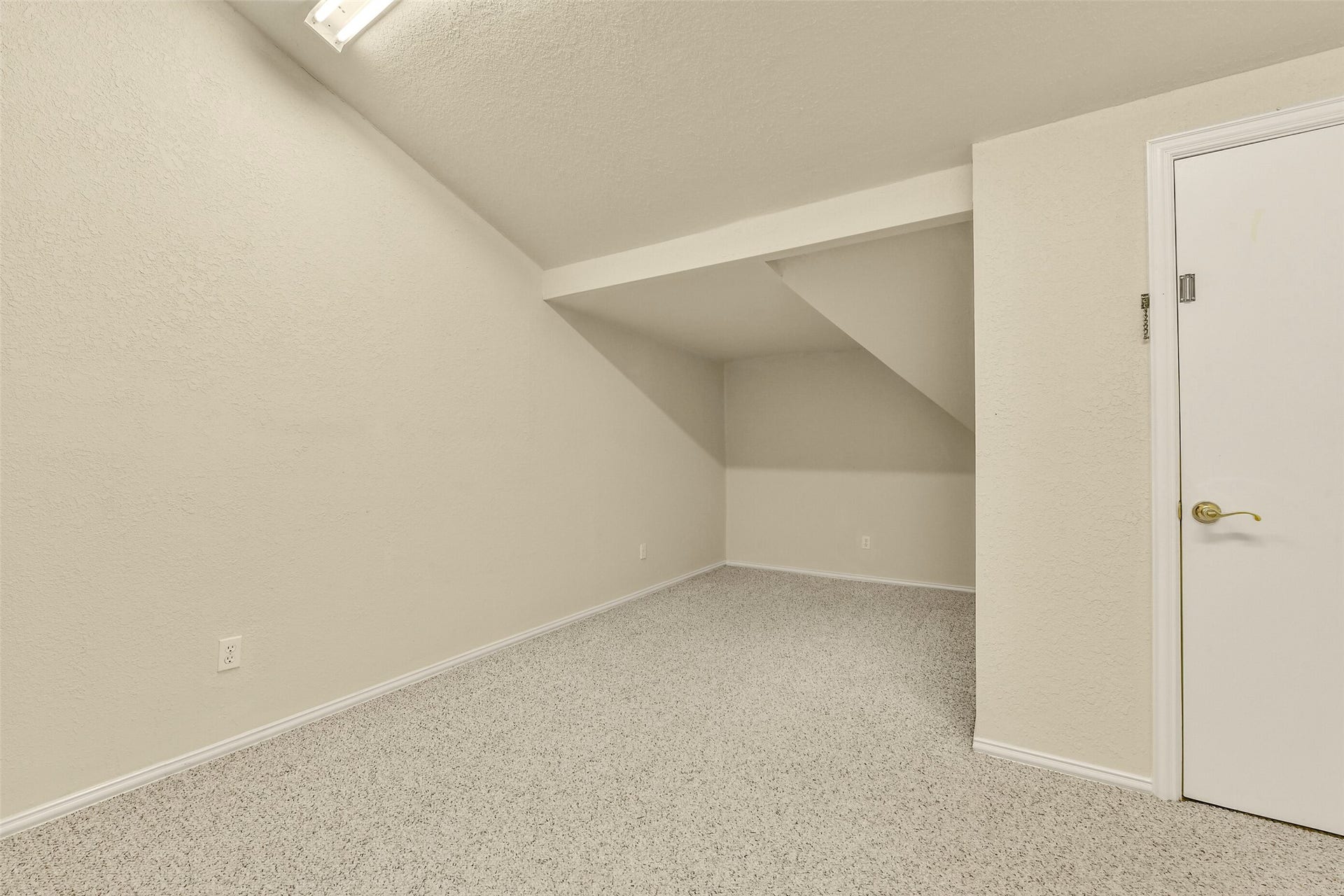 9902 Autumn Lake Trail, Pearland, TX 77584 Bright and versatile storage room with sloped ceiling, perfect for storage or a cozy workspace.