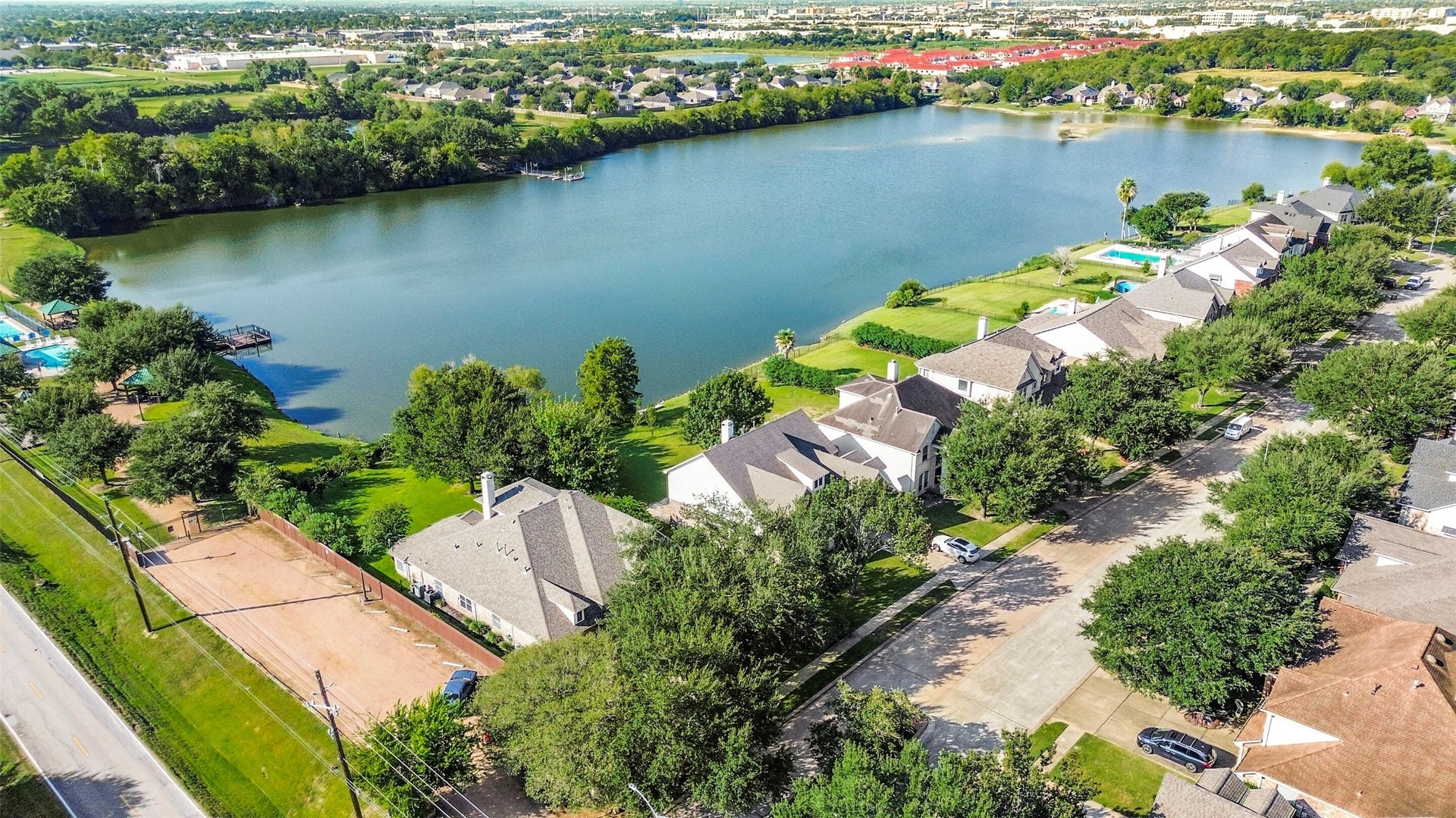 9902 Autumn Lake Trail, Pearland, TX 77584 Charming lakeside community featuring elegant homes with lush greenery and serene water views, perfect for tranquil living. Home is first on the left,