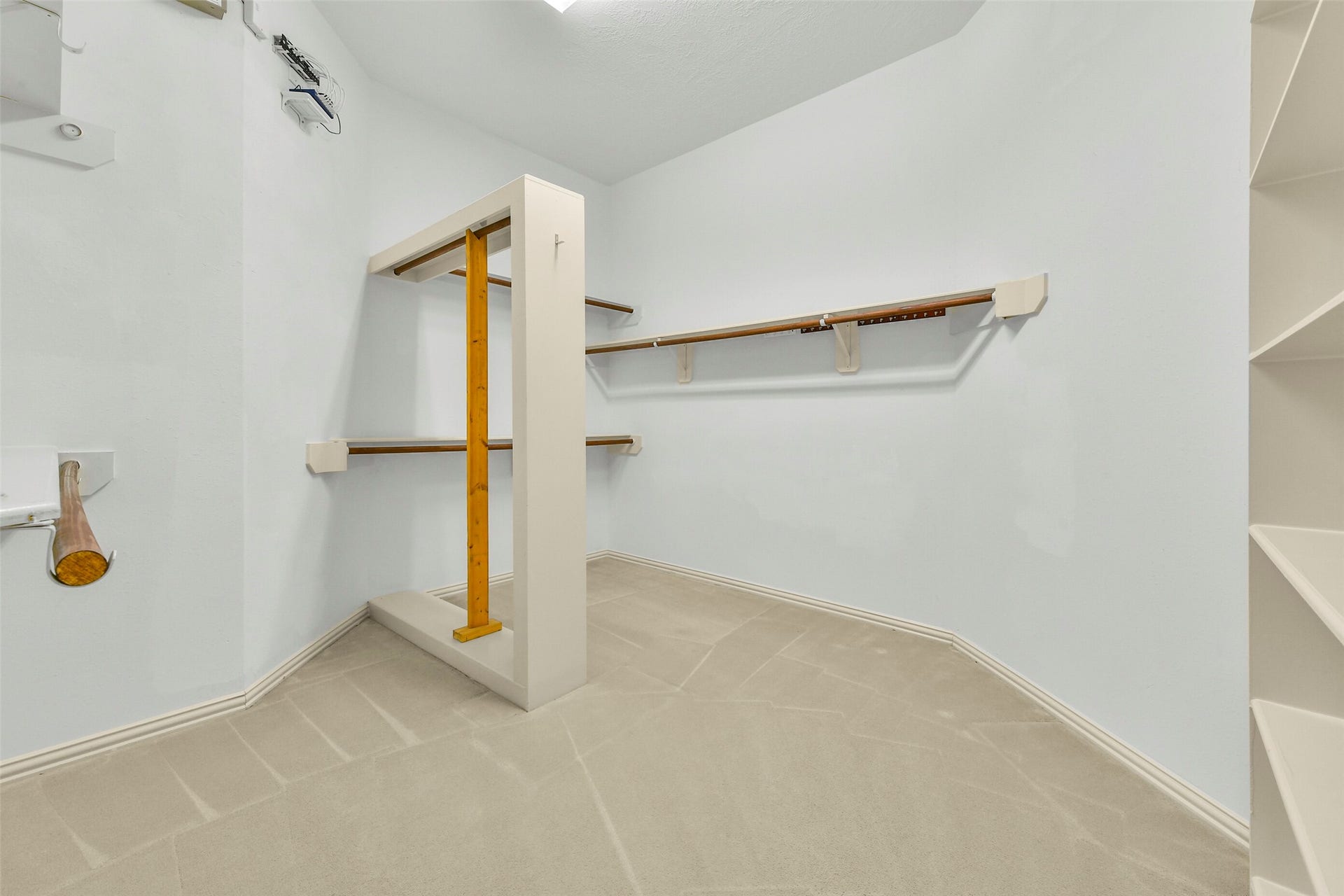 9902 Autumn Lake Trail, Pearland, TX 77584 Spacious walk-in closet with ample hanging space and built-in shelving for organized storage.