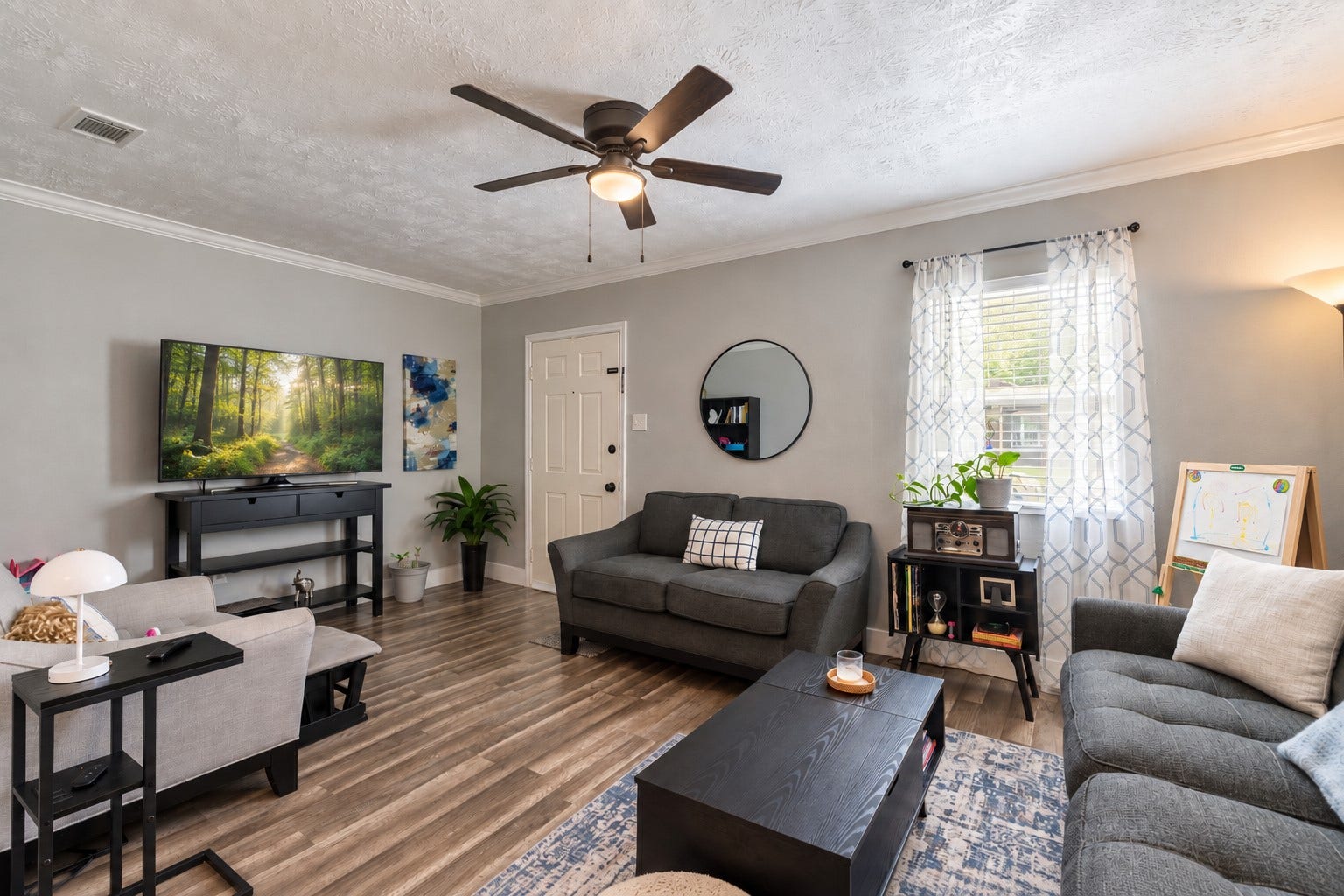 903 Willow Street, Pasadena, TX 77506 Bright and inviting living room featuring updated flooring, neutral tones, ample natural light, and a comfortable open layout perfect for everyday living.