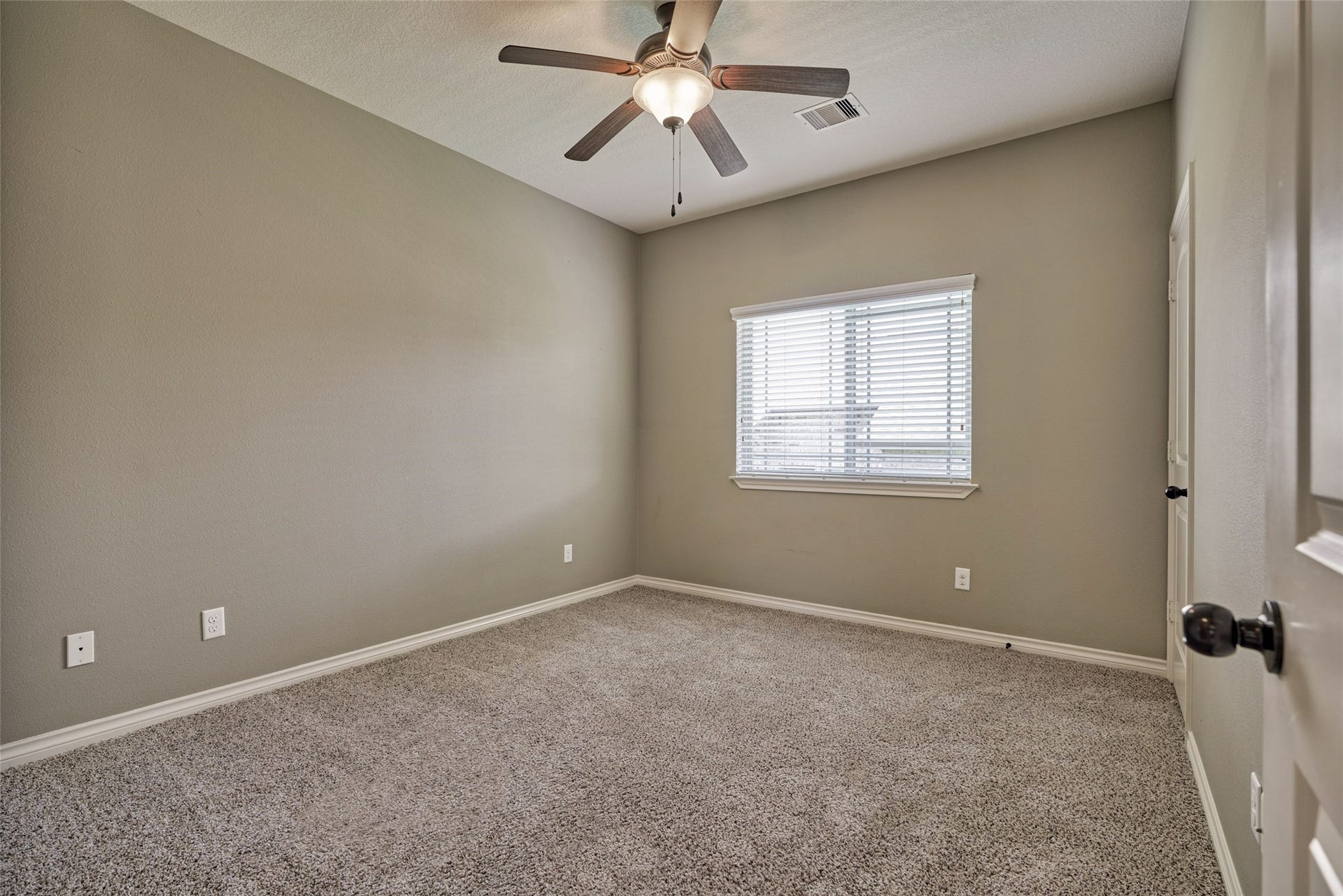 119 Bessie Price Owens Drive, Montgomery, TX 77356 This is one of the two secondary bedrooms with ceiling fan and plush carpeting.