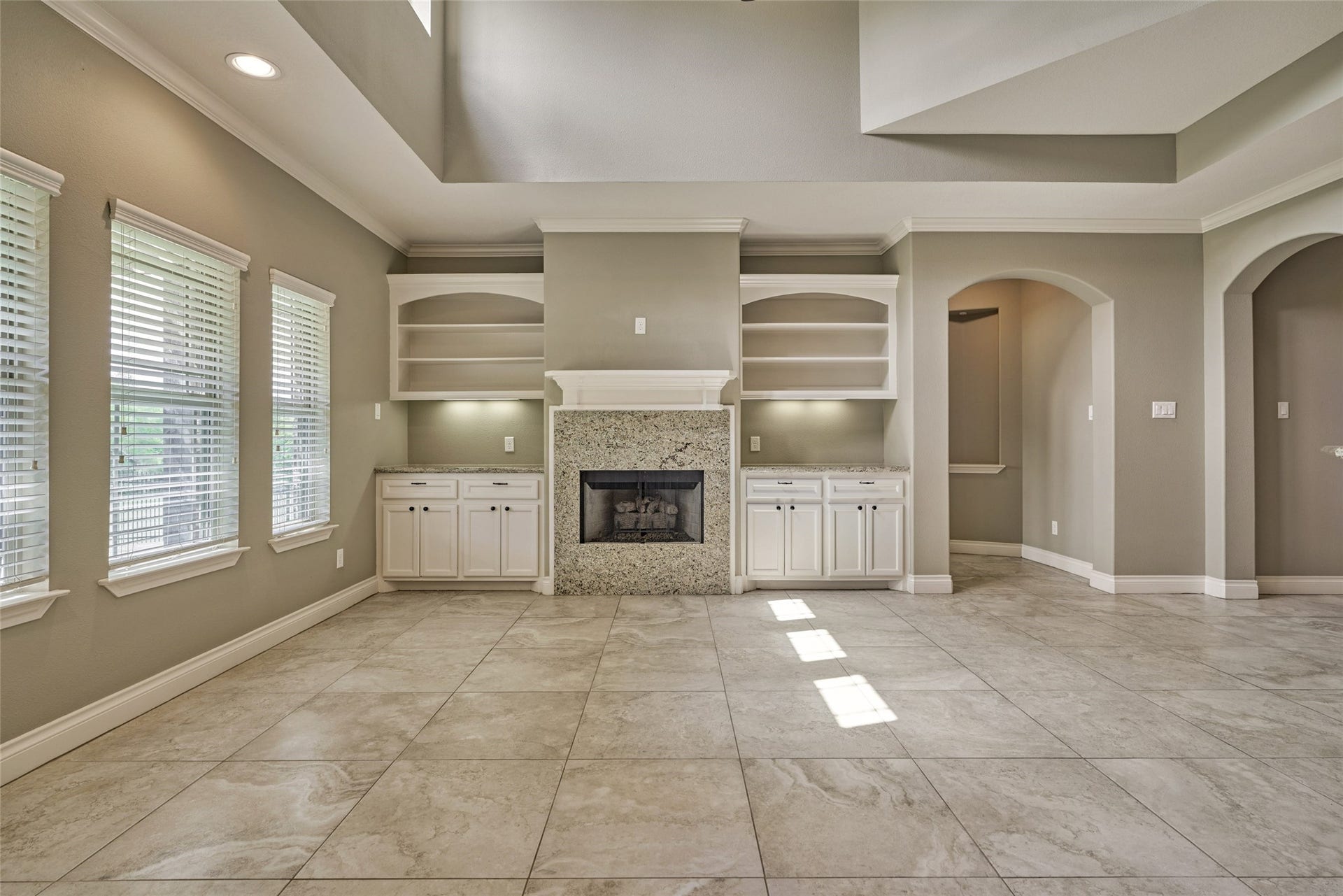 119 Bessie Price Owens Drive, Montgomery, TX 77356 The arch to the right of the entertainment center leads to the spacious primary bedroom.