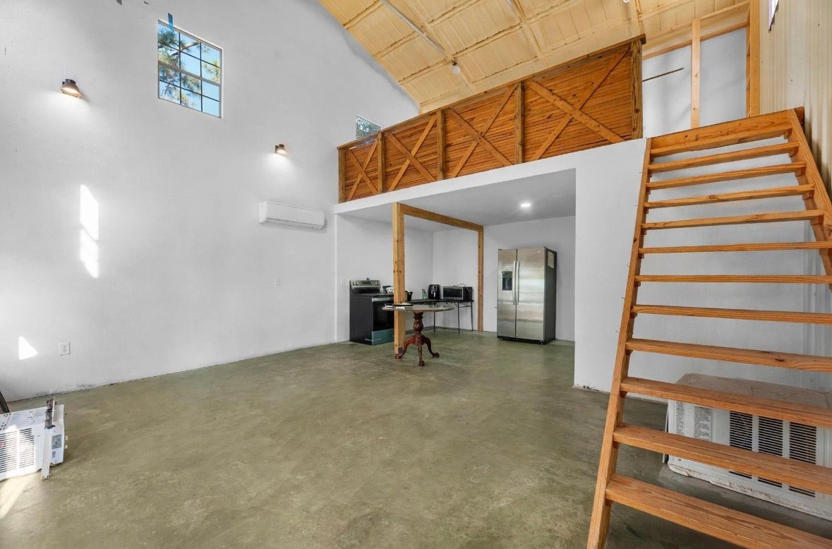 32403 Dobbin Huffsmith Road, Magnolia, TX 77354 loft space attached to workshop offering a versatile 1-bedroom, 1-bath layout with additional living or workspace potential.