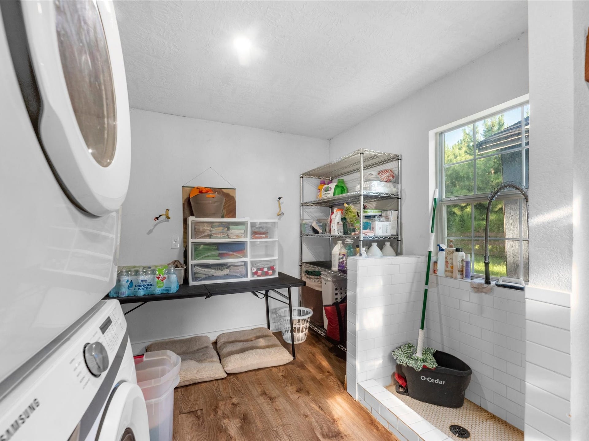 32403 Dobbin Huffsmith Road, Magnolia, TX 77354 Convenient utility room featuring a bonus shower area, perfect for washing pets, muddy shoes, or other everyday cleanup needs.