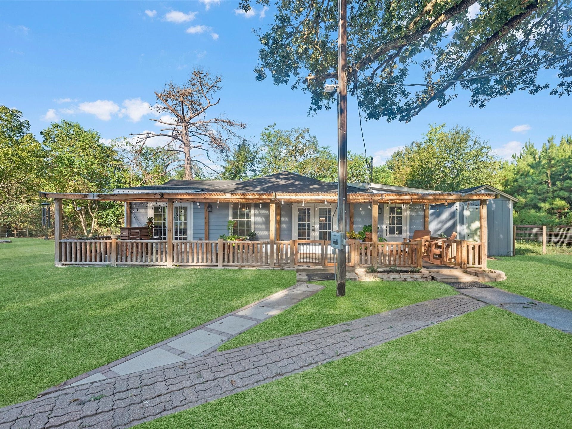 32403 Dobbin Huffsmith Road, Magnolia, TX 77354 Recently renovated 2-bedroom, 2-bath home offering approximately 1,250 sq ft of living space with a welcoming front porch.