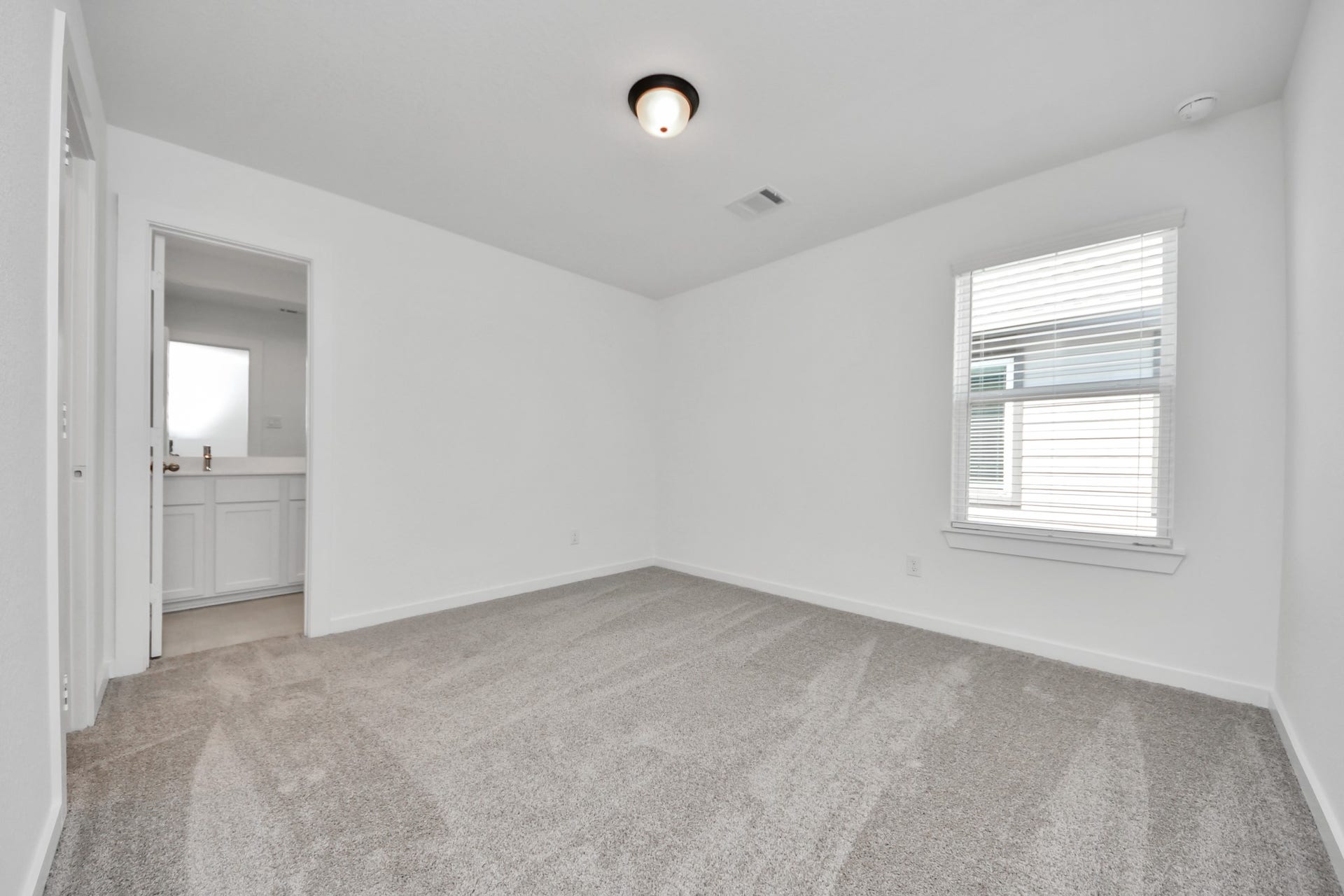Generously sized secondary bedrooms featuring spacious closets, soft and inviting carpeting underfoot, large windows allowing plenty of natural light, and the added touch of privacy blinds for your personal retreat. Sample photo of completed home with similar floor plan. Actual colors and selections may vary.