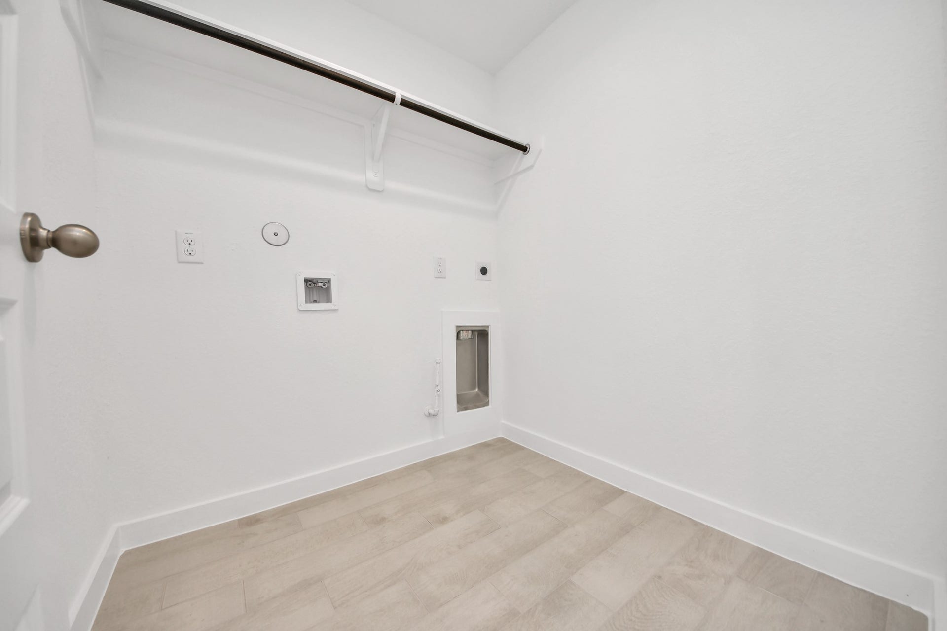A perfect blend of functionality and comfort. Capture the essence of easy living with a first-floor laundry room, thoughtfully equipped with shelving for effortless organization. Both electric and gas connections available. Sample photo of completed home with similar floor plan. Actual colors and selections may vary.