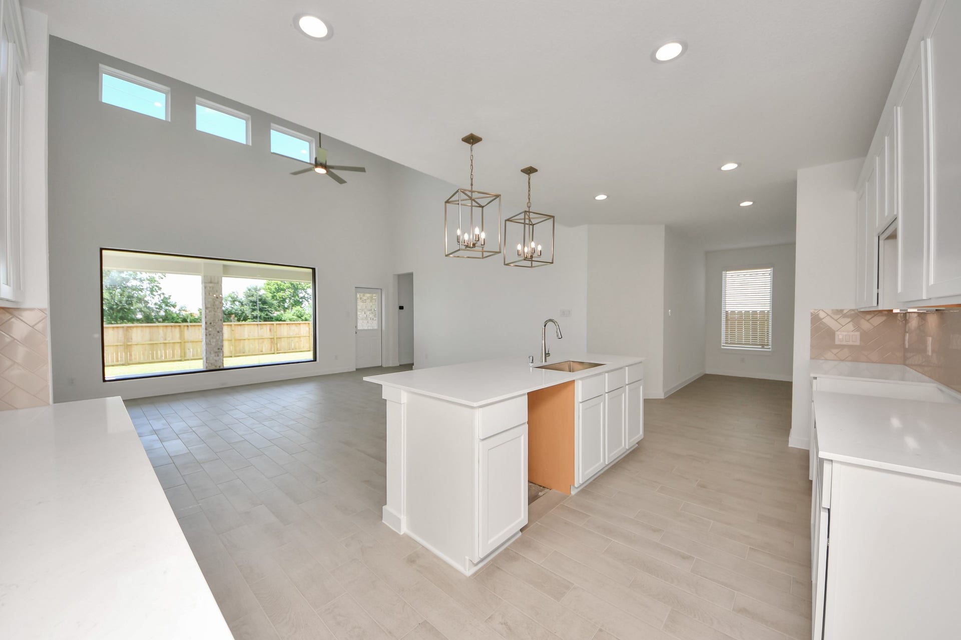 All of this overlooks your expansive family room, creating a perfect space for culinary delights and family gatherings. Sample photo of completed home with similar floor plan. Actual colors and selections may vary.