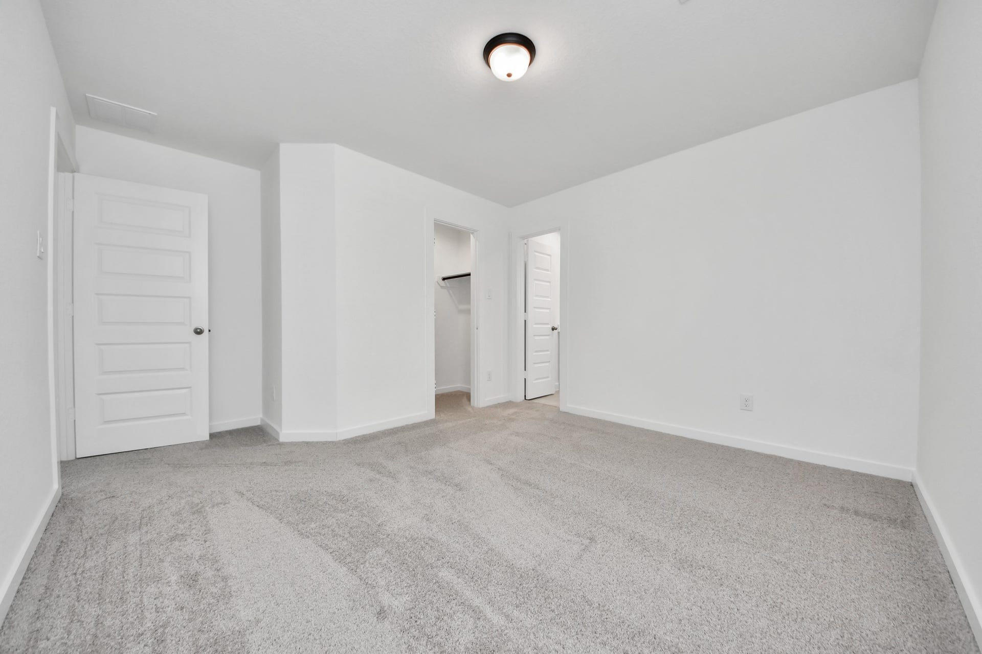 Secondary bedroom features plush carpeting, large windows that let in plenty of natural light, bright paint, and spacious closets. Sample photo of completed home with similar floor plan. Actual colors and selections may vary.