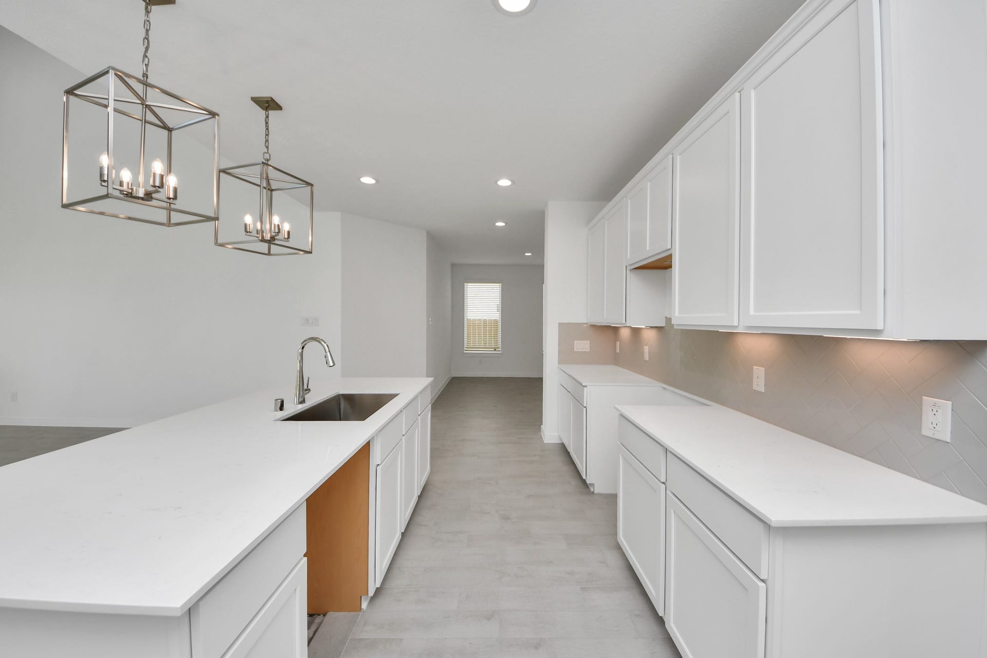 Discover another perspective of this stunning kitchen, generously appointed with an abundance of counter space. Sample photo of completed home with similar floor plan. Actual colors and selections may vary.
