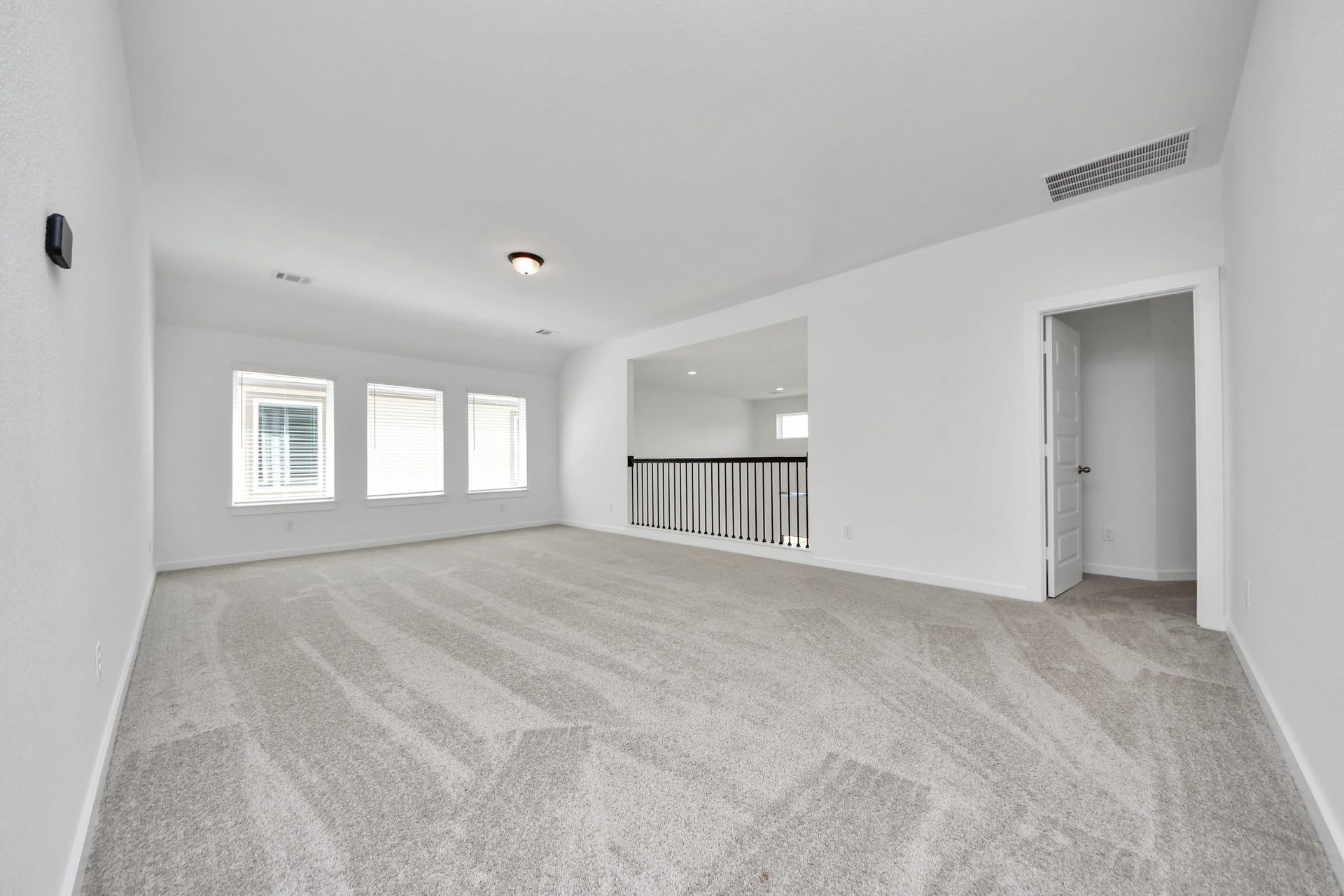 Ascend to relaxation in this fantastic game room! Ideal for both casual gatherings and adult gaming, it boasts plush carpet, lofty ceilings, custom paint, and ample windows for abundant natural light. Sample photo of completed home with similar floor plan. Actual colors and selections may vary.
