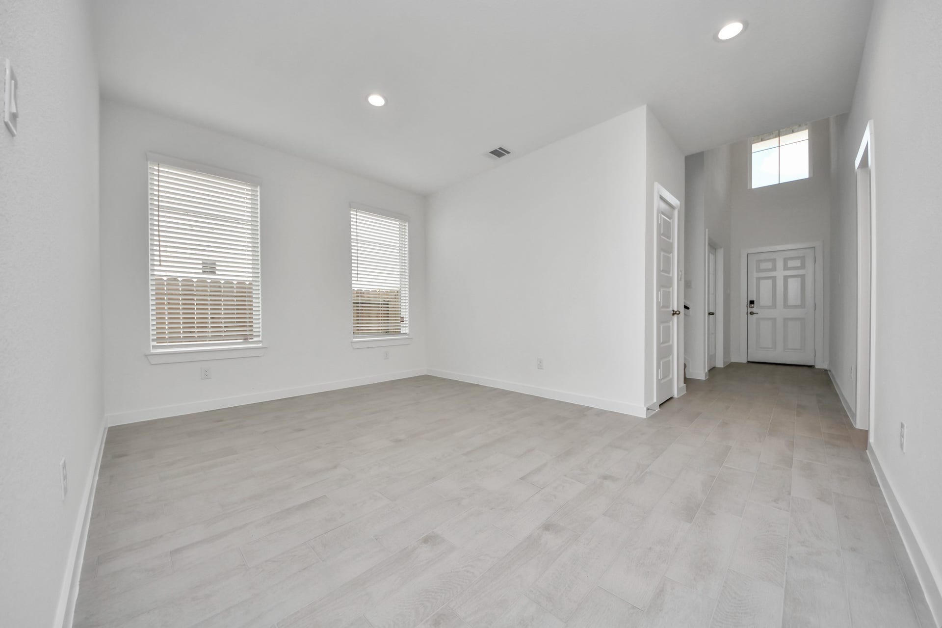 Create lasting memories with your family and friends at the dining table! This expansive dining room showcases sophisticated flooring, custom paint, and seamlessly connects to the family room and kitchen, providing an open and inviting atmosphere. Sample photo of completed home with similar floor plan. Actual colors and selections may vary.