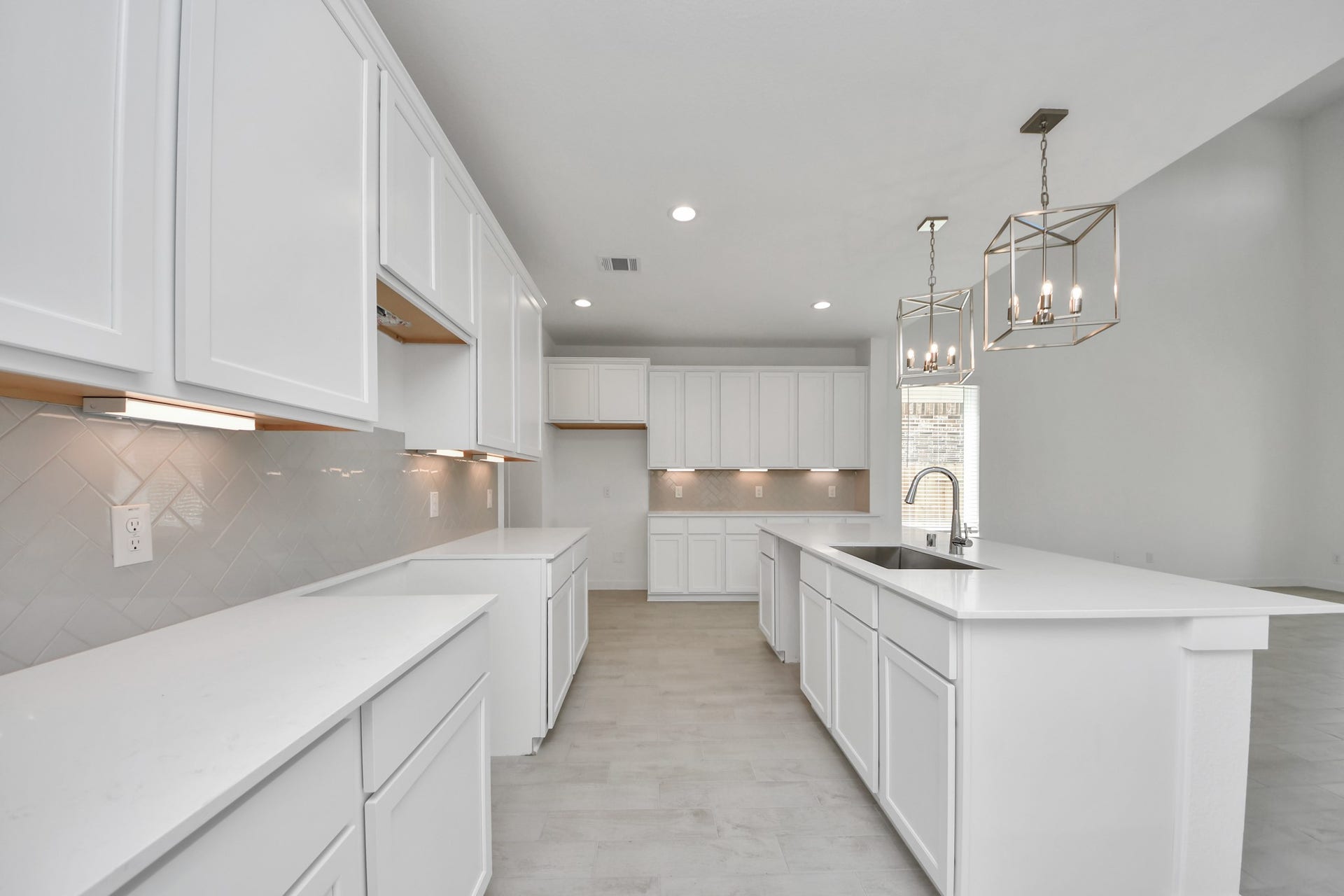 The kitchen is a culinary haven, featuring granite countertops, a tile backsplash, stainless steel appliances, 42 upper cabinets, and undercabinet lighting. Sample photo of completed home with similar floor plan. Actual colors and selections may vary.